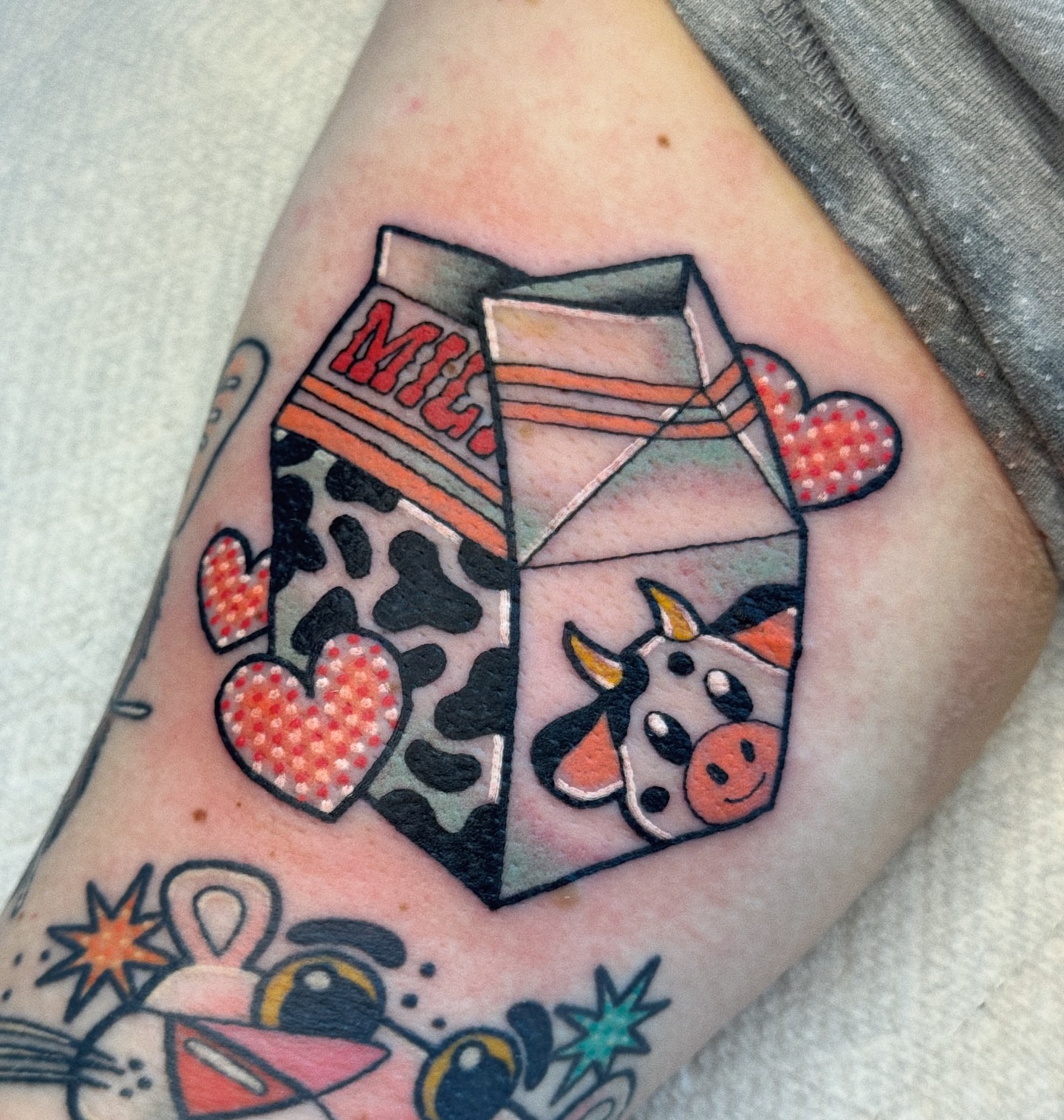 Milk carton with cow American traditional tattoo on the forearm by 𝕷𝖆𝖚𝖗 𝕷𝖆𝖚𝖗