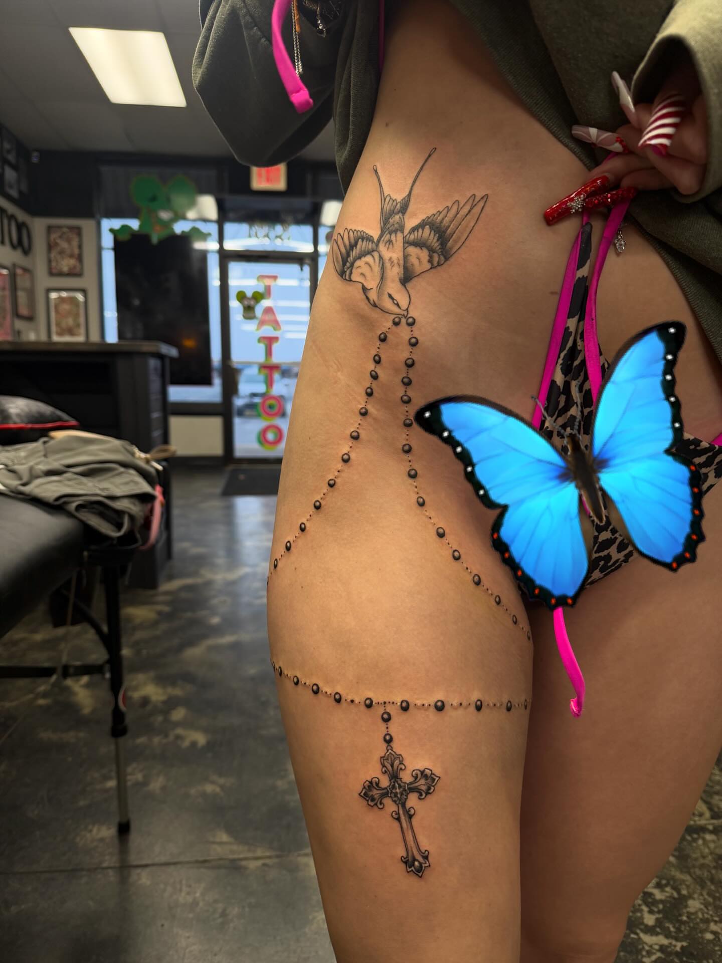 Rosary and butterfly dotwork tattoo on the thigh by Kylee langford 🧿