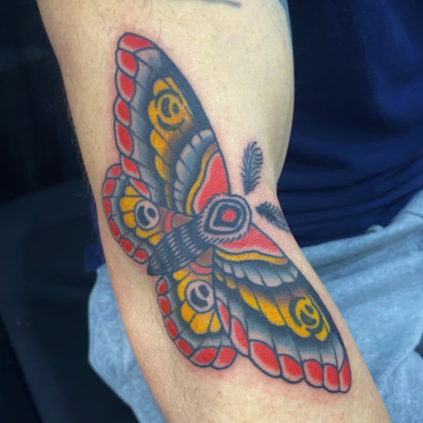 Butterfly American traditional tattoo on the forearm by @katie_tatts