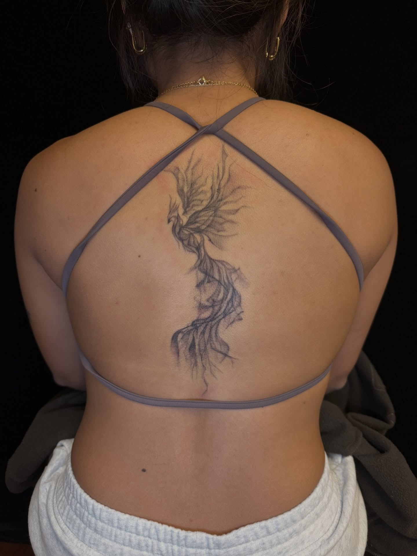 Phoenix black and grey tattoo on the back by Maddie Blosser, Portland, Oregon