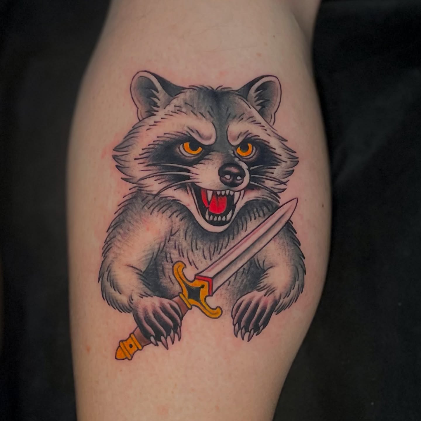 Raccoon holding sword American traditional tattoo on the forearm by Ｊｉｍ Ｓｙｌｖｉａ