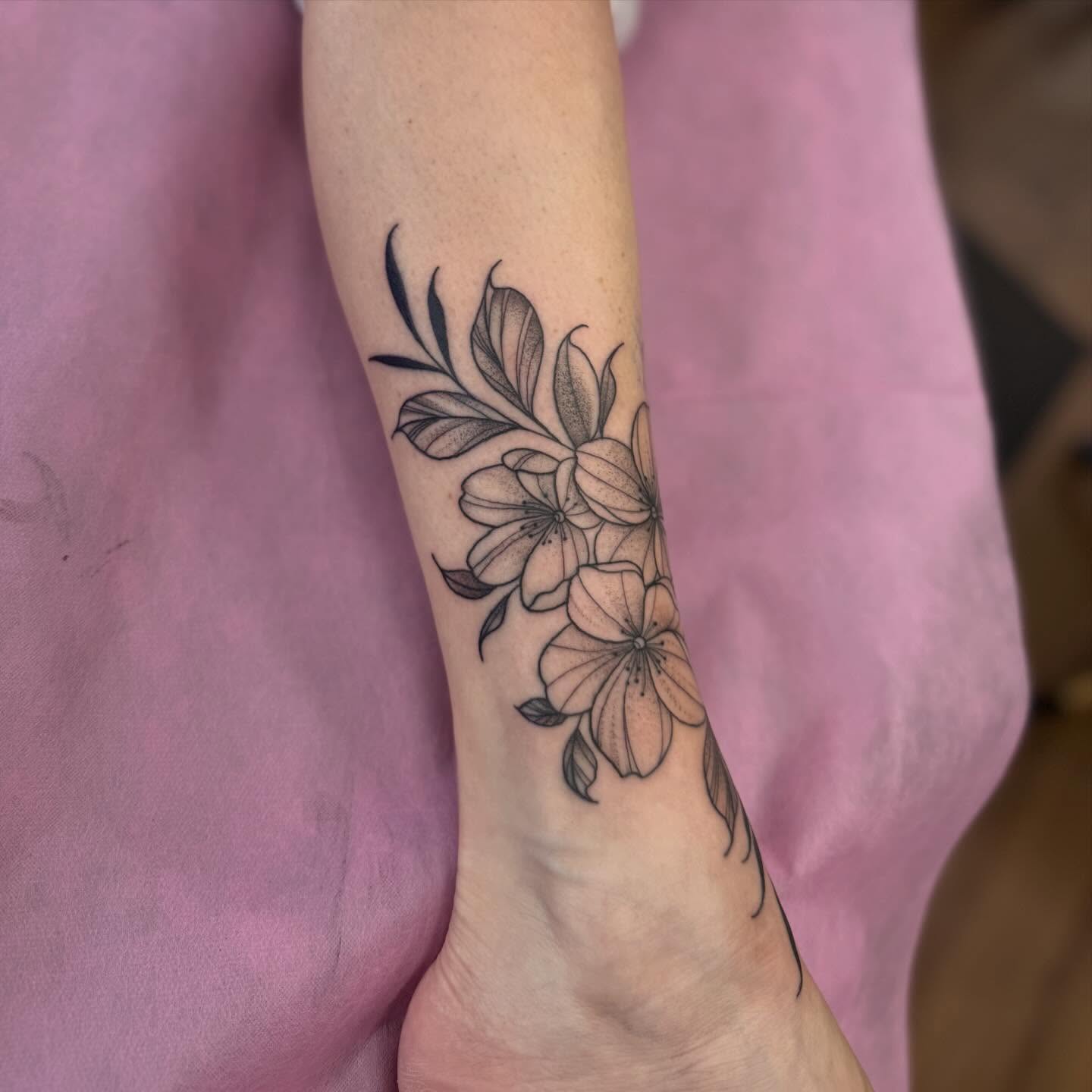 Flowers black and grey tattoo on the forearm by Erica Rose π€