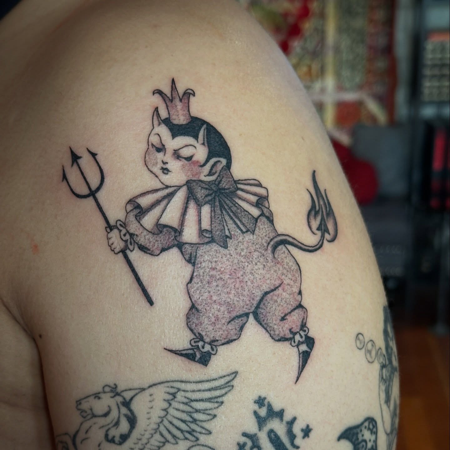 Clown devil black and grey tattoo on the shoulder by Bree Lin