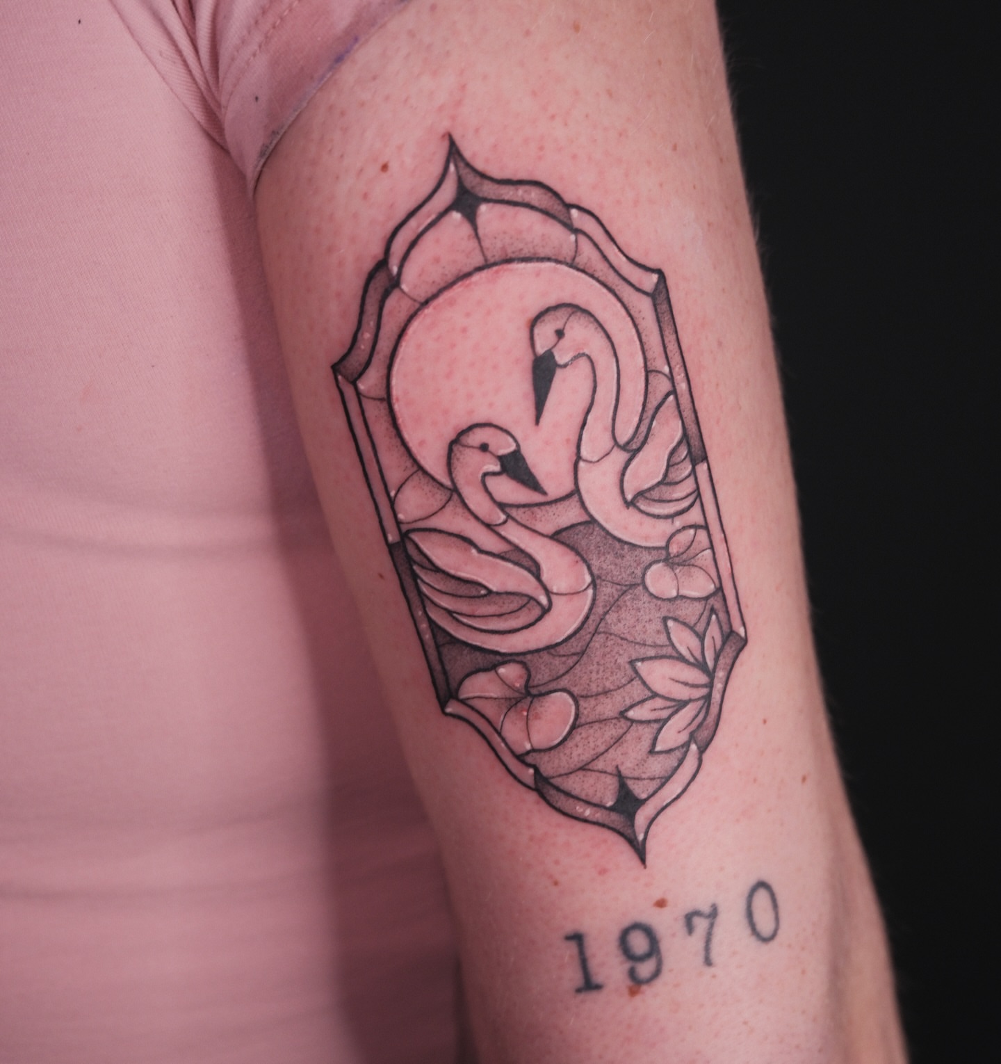 Swans and floral black and grey tattoo on the forearm by Velvet, Seattle, Washington