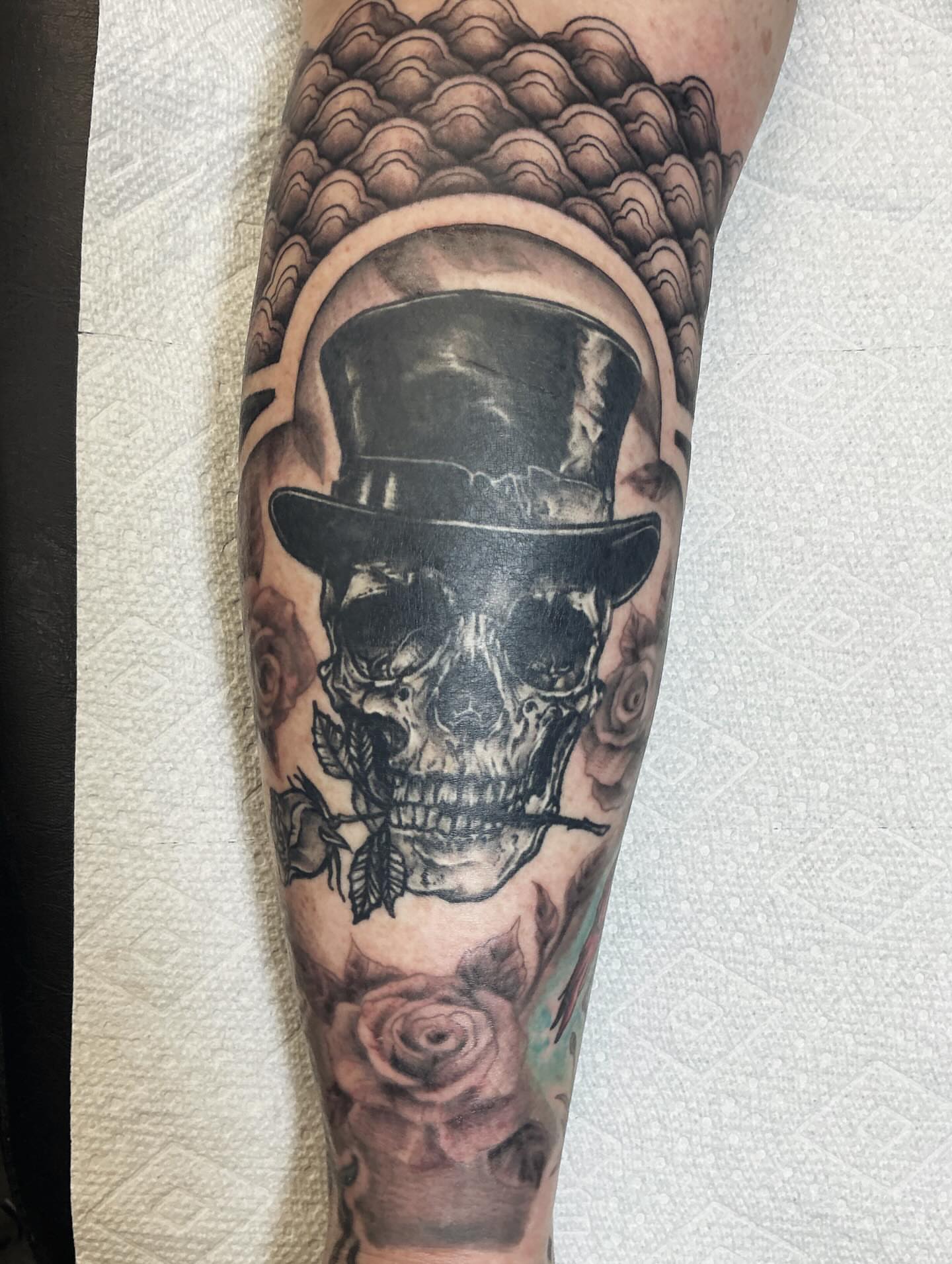 Skull wearing top hat realism tattoo on the forearm by Brookelyn