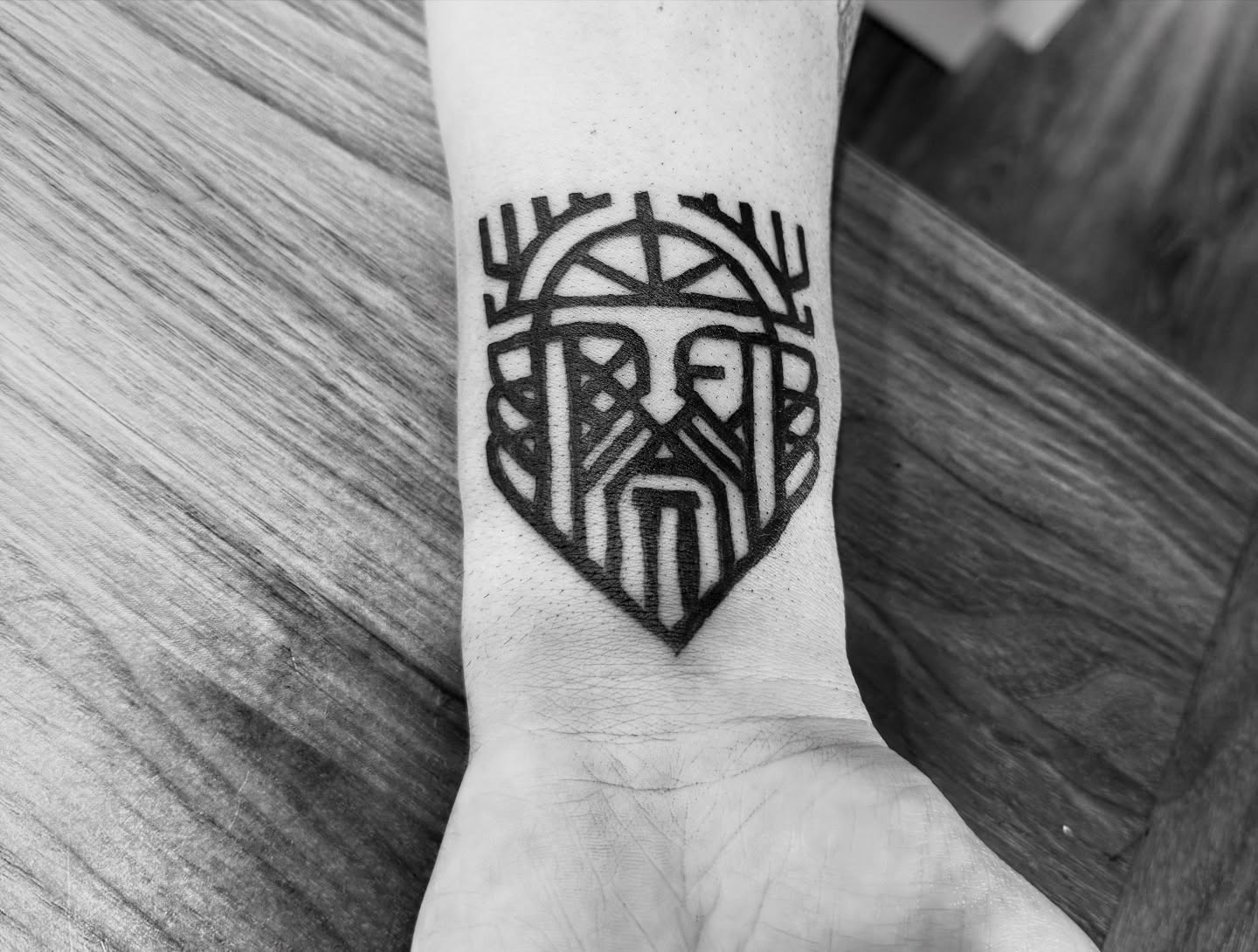 Geometric mask geometric tattoo on the forearm by Whimsy Ink