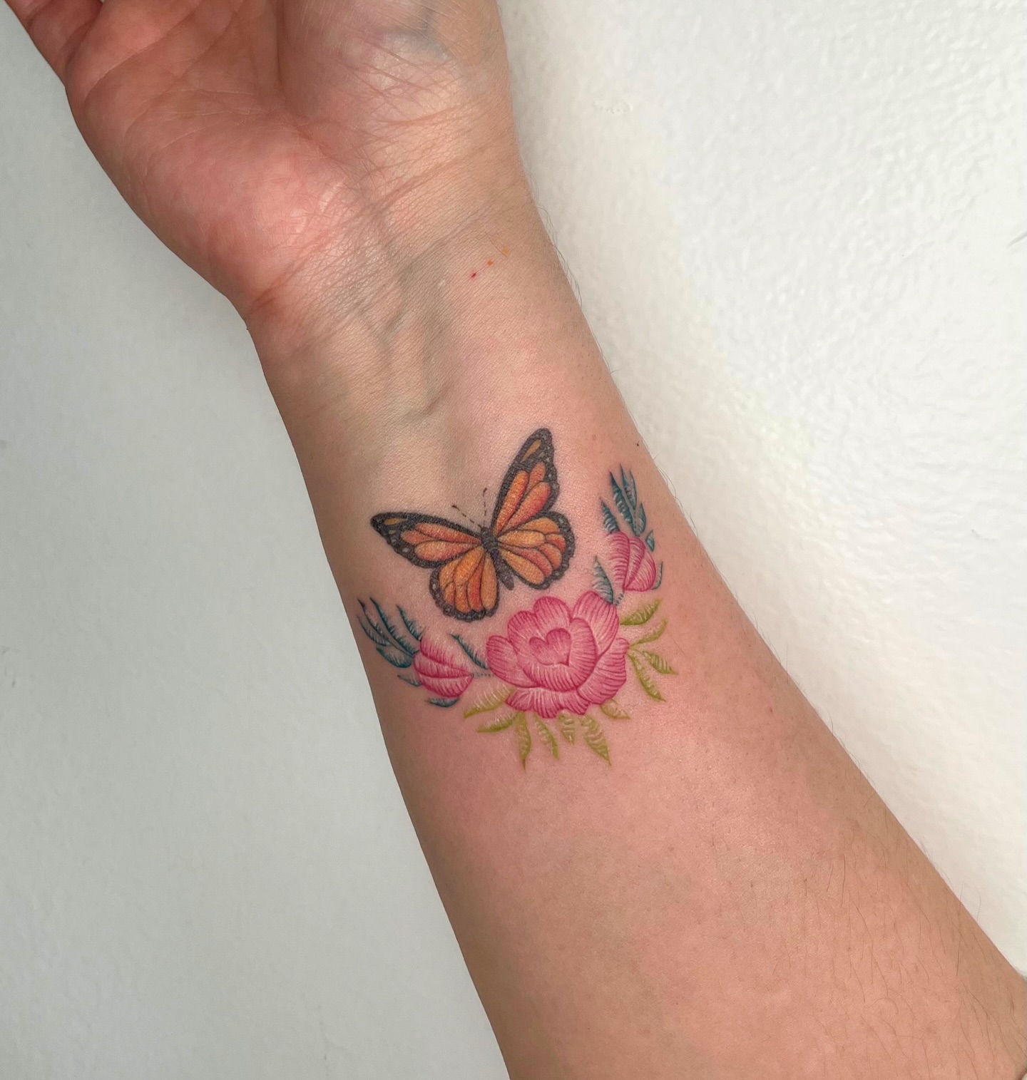 Butterfly and flowers new school tattoo on the forearm by kt