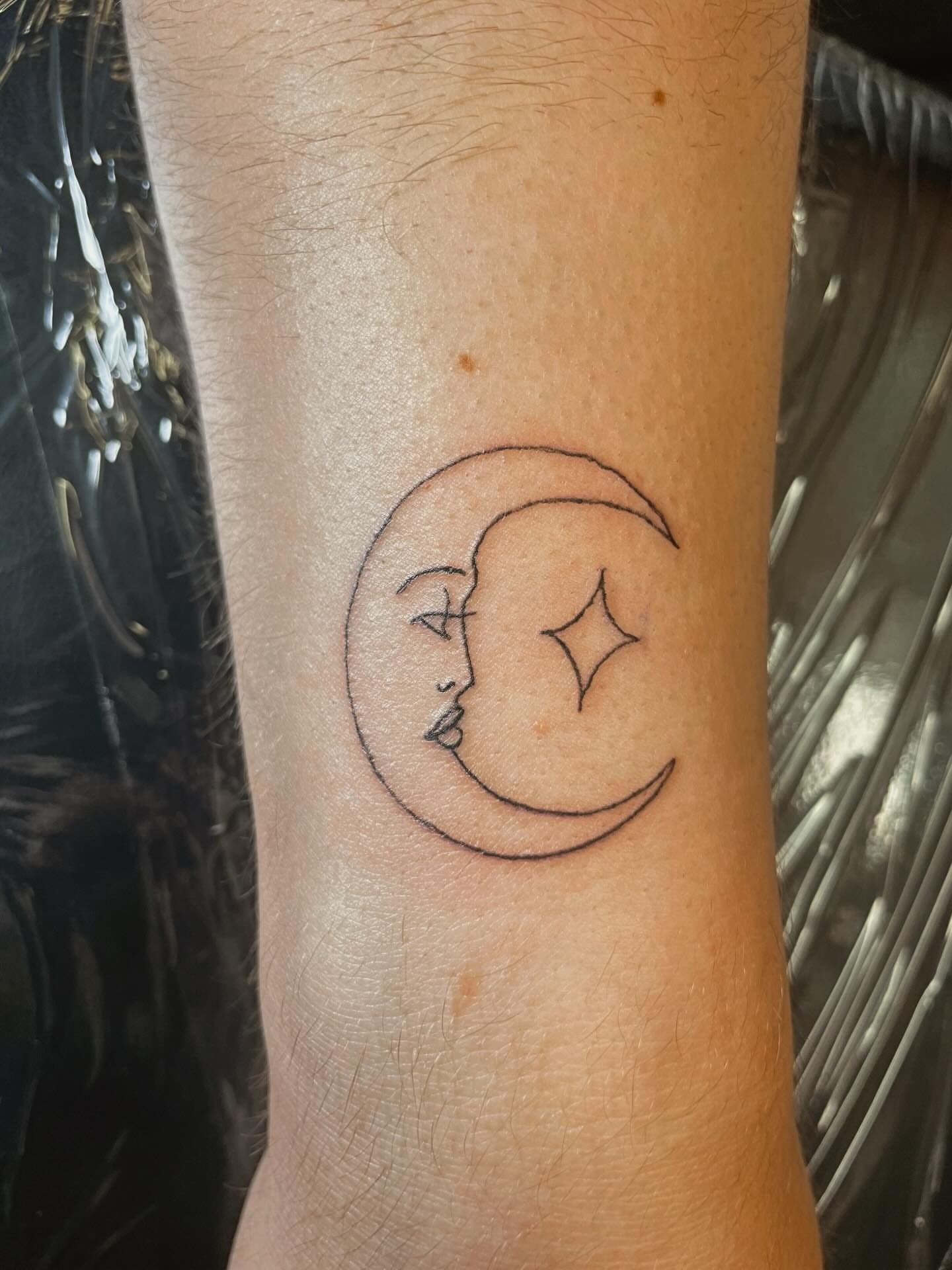 Moon and star minimalist tattoo on the forearm by 𝚃𝙰𝚃𝚃𝙾𝙾 𝙰𝚁𝚃𝙸𝚂𝚃, Charlotte, North Carolina