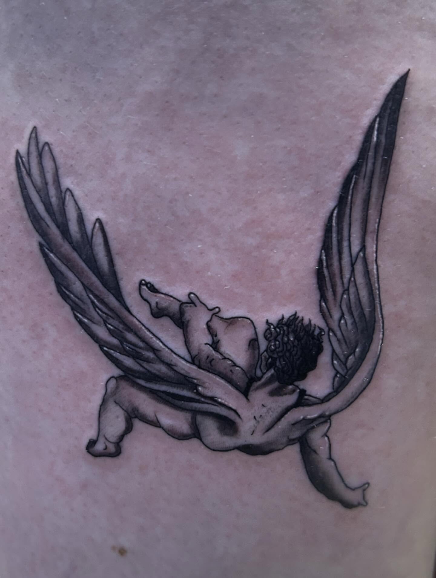 Falling angel black and grey tattoo on the chest by Ashley Lambert