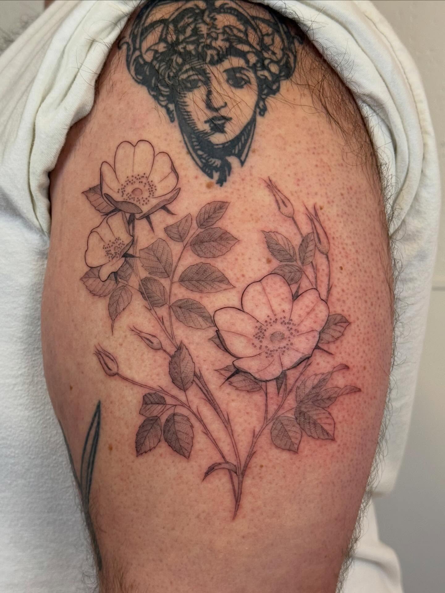 Flowers and woman's head realism tattoo on the shoulder by Justin Turkus