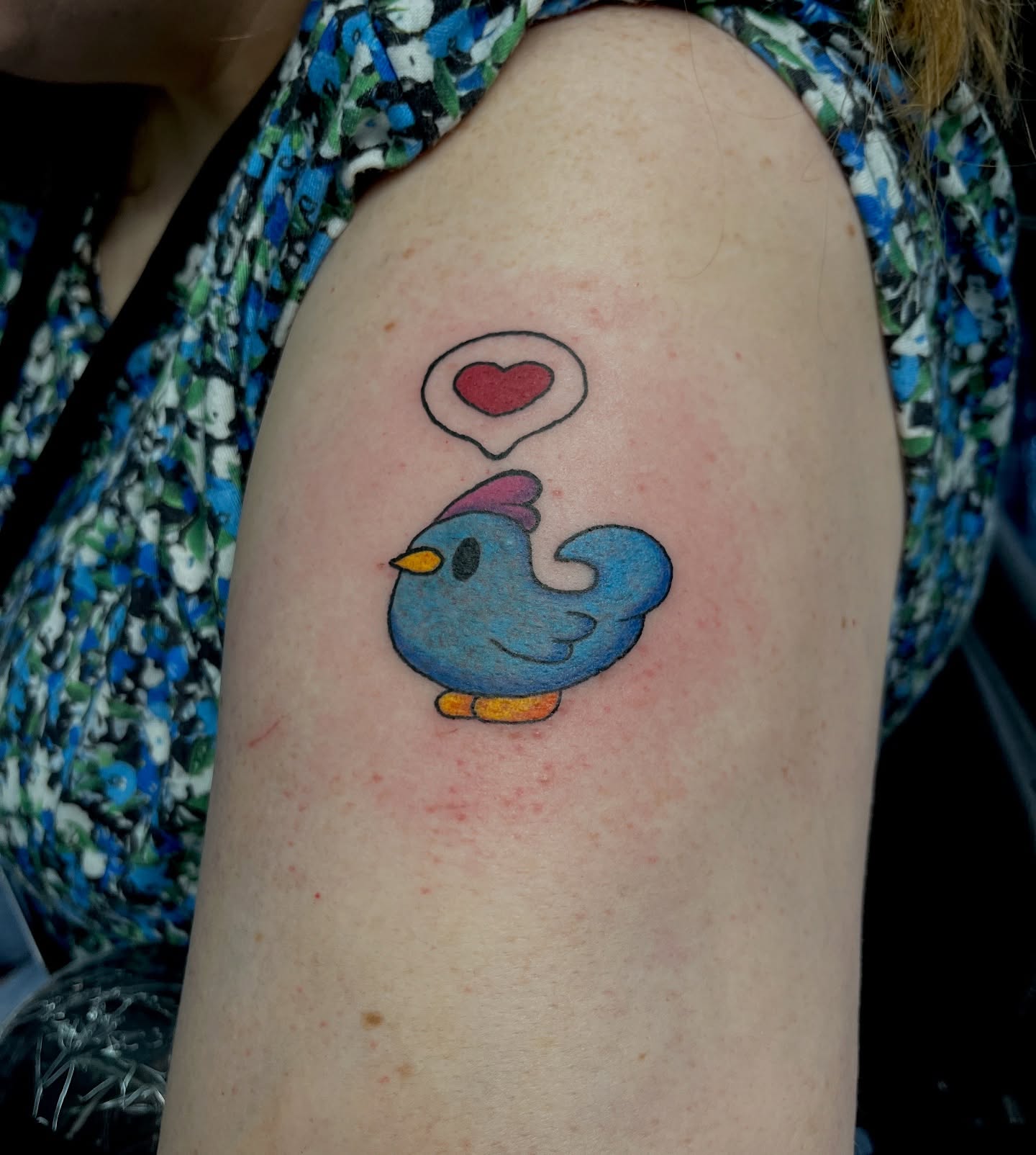 Bird with heart dotwork tattoo on the shoulder by Cheyanne Peck