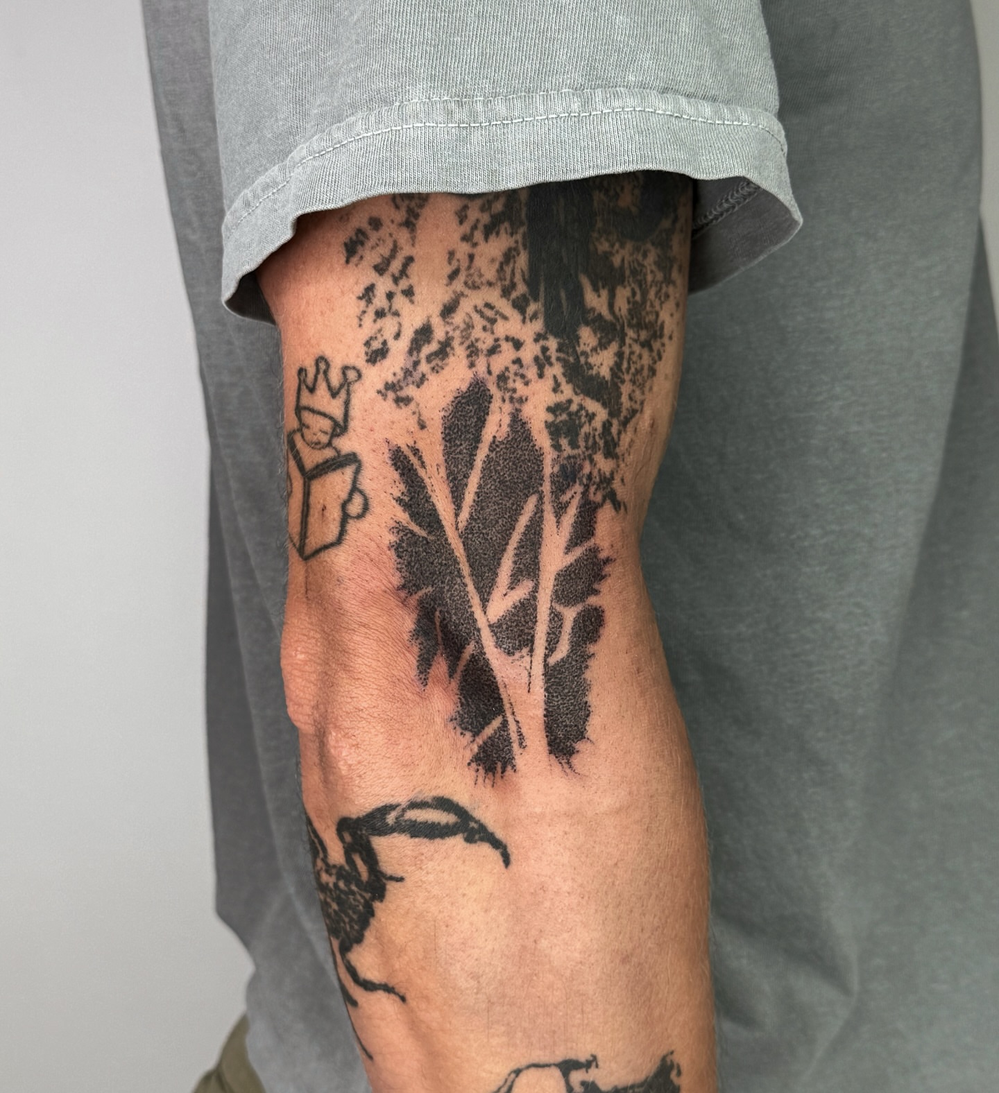 Abstract plant black and grey tattoo on the forearm by Joint Killer