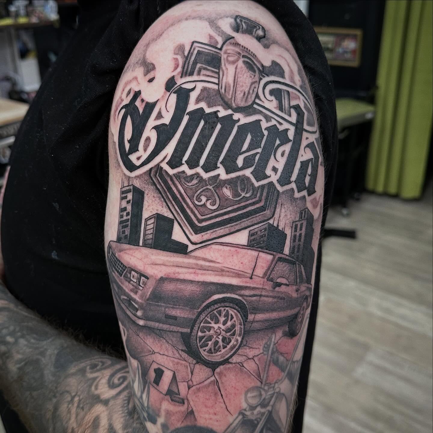 Car and cityscape realism tattoo on the forearm by Dustin Clark, Dayton, Ohio