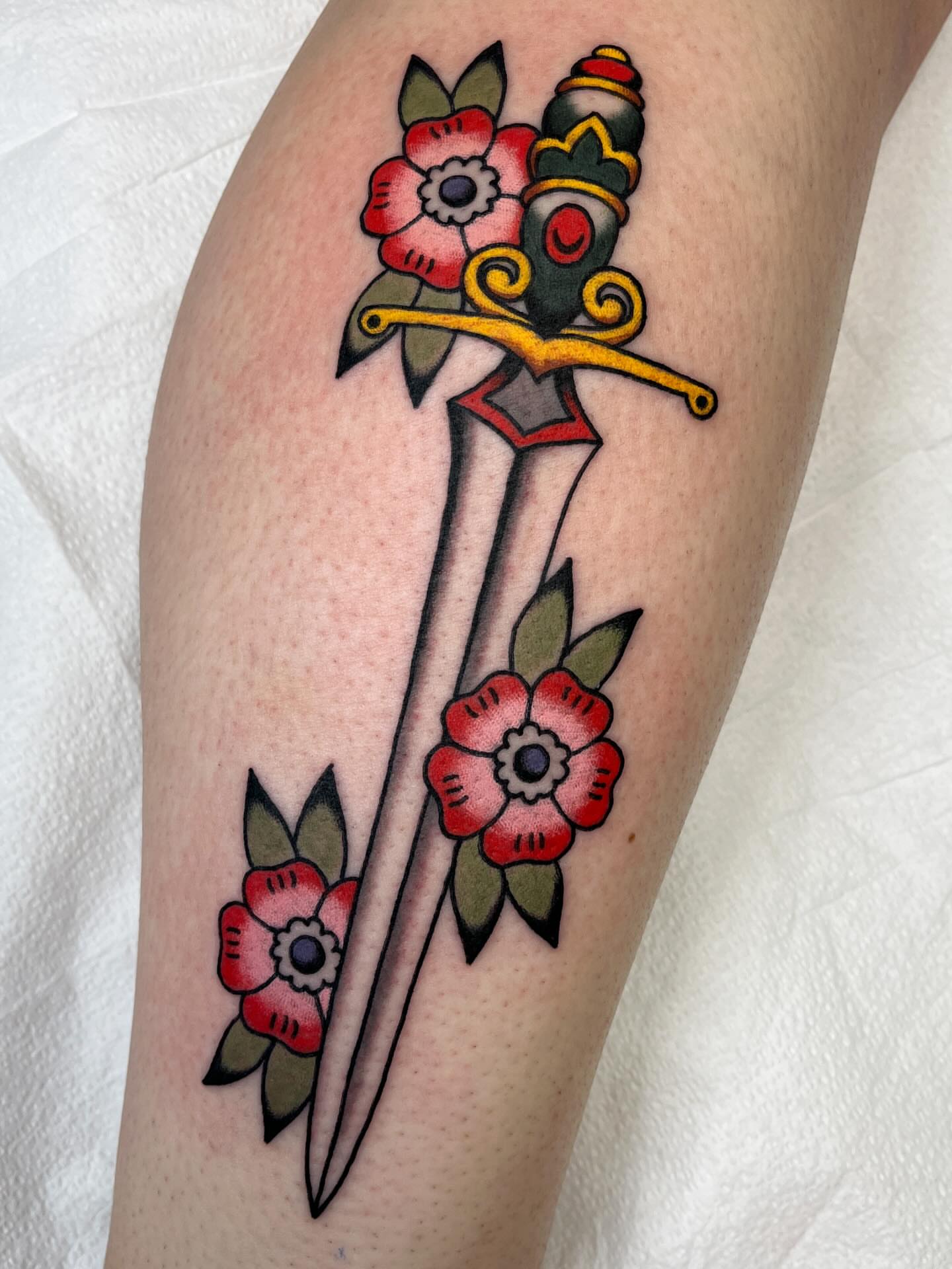 Sword and flowers American traditional tattoo on the forearm by 🌞all Bodies Welcome🌞