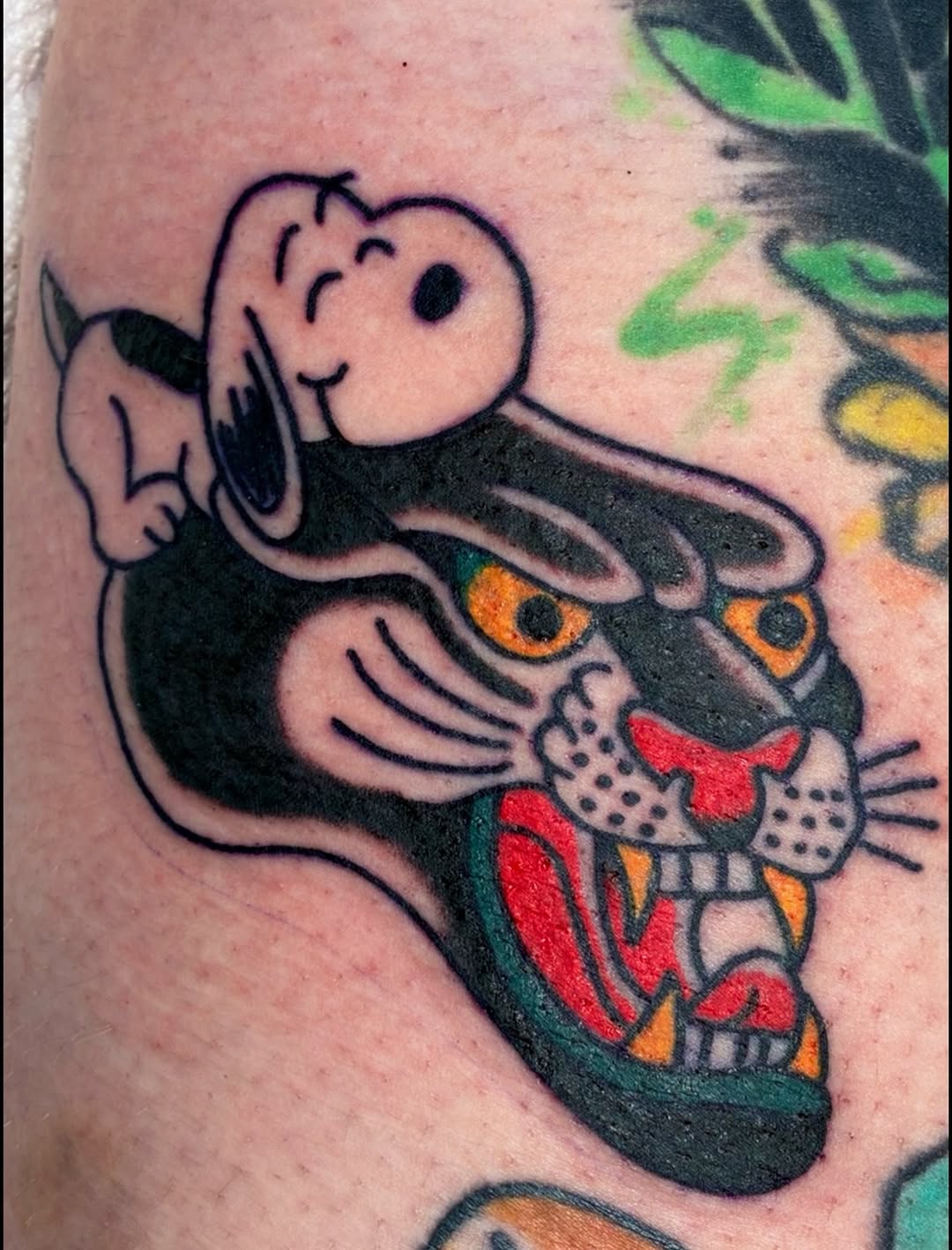 Panther with Snoopy on top realism tattoo on the forearm by Sav Robinson