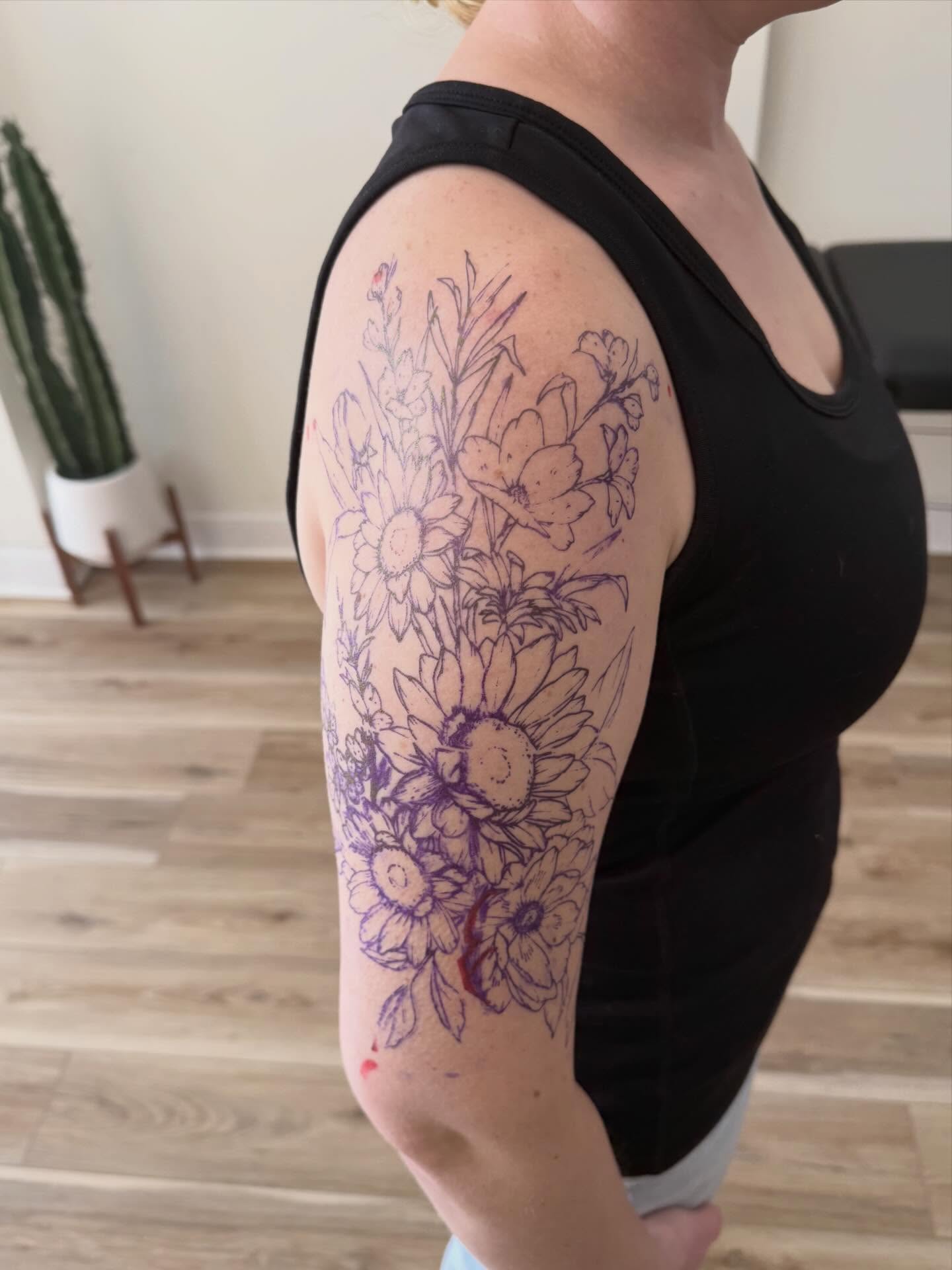 Floral bouquet black and grey tattoo on the upper arm by Daniel Anthony, Philadelphia, Pennsylvania