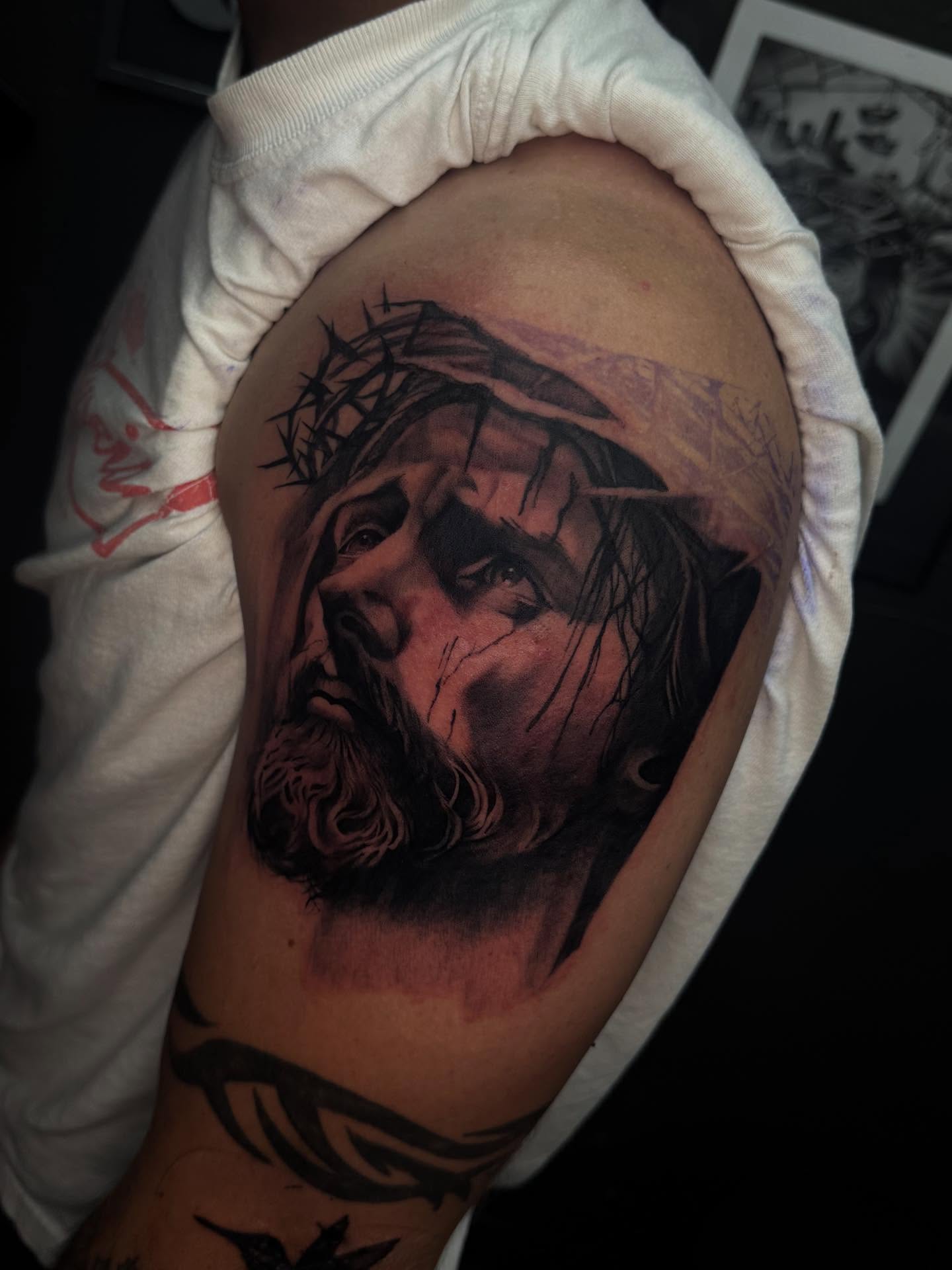 Jesus Christ realism tattoo on the shoulder by Smuk One