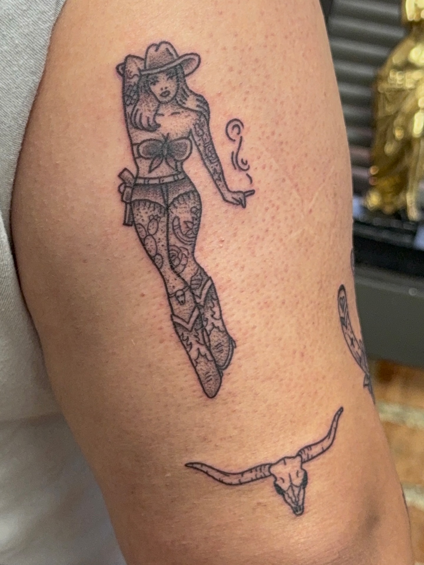 Cowgirl black and grey tattoo on the thigh by Royal Martinez
