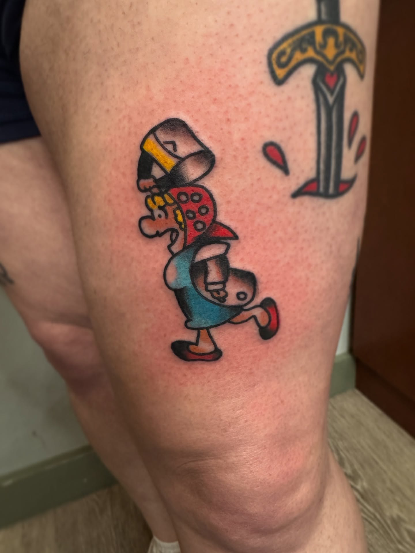 Alice in wonderland character American traditional tattoo on the thigh by Andrew Snowden