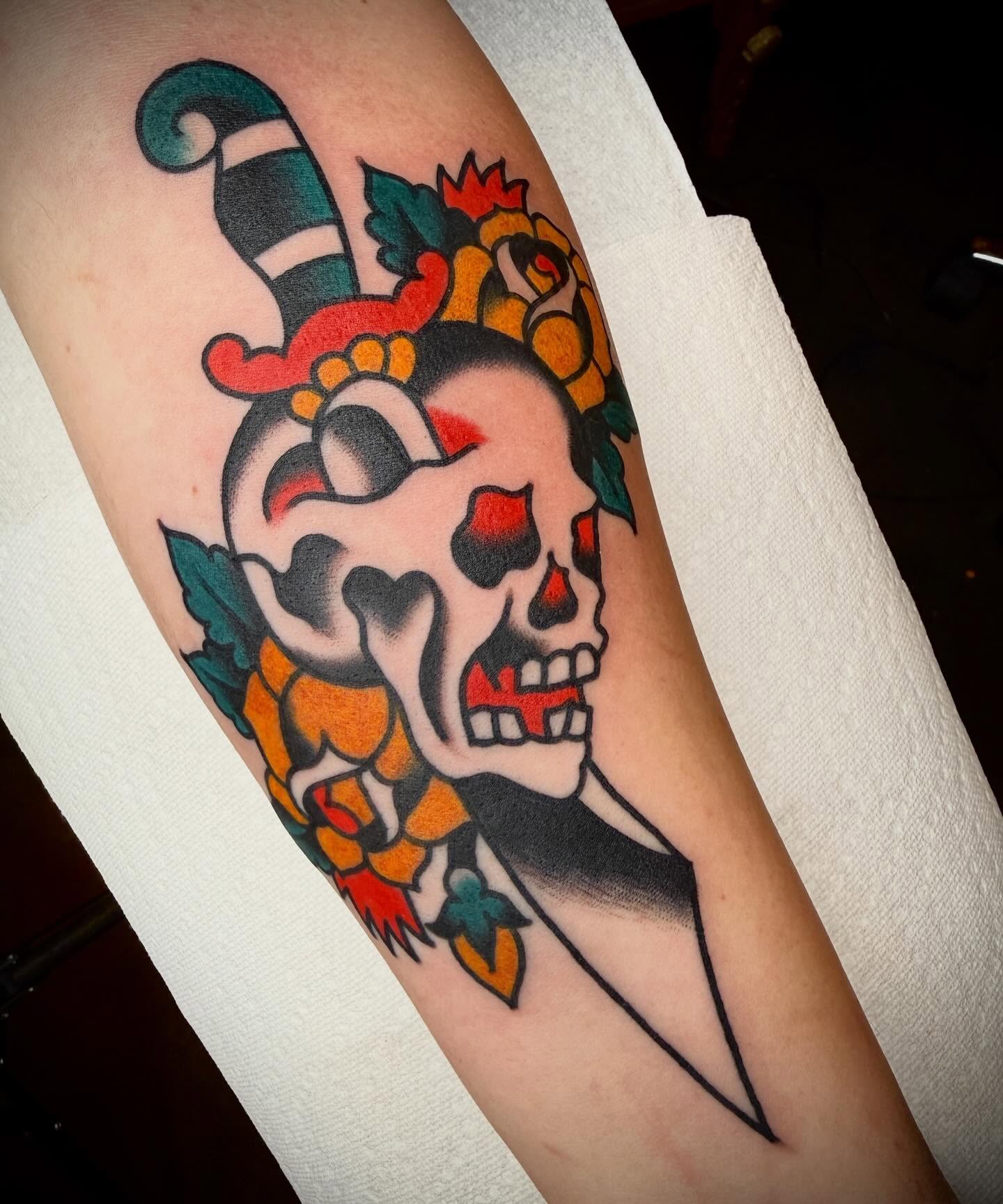 Jester skull American traditional tattoo on the forearm by Tristan Bradshaw