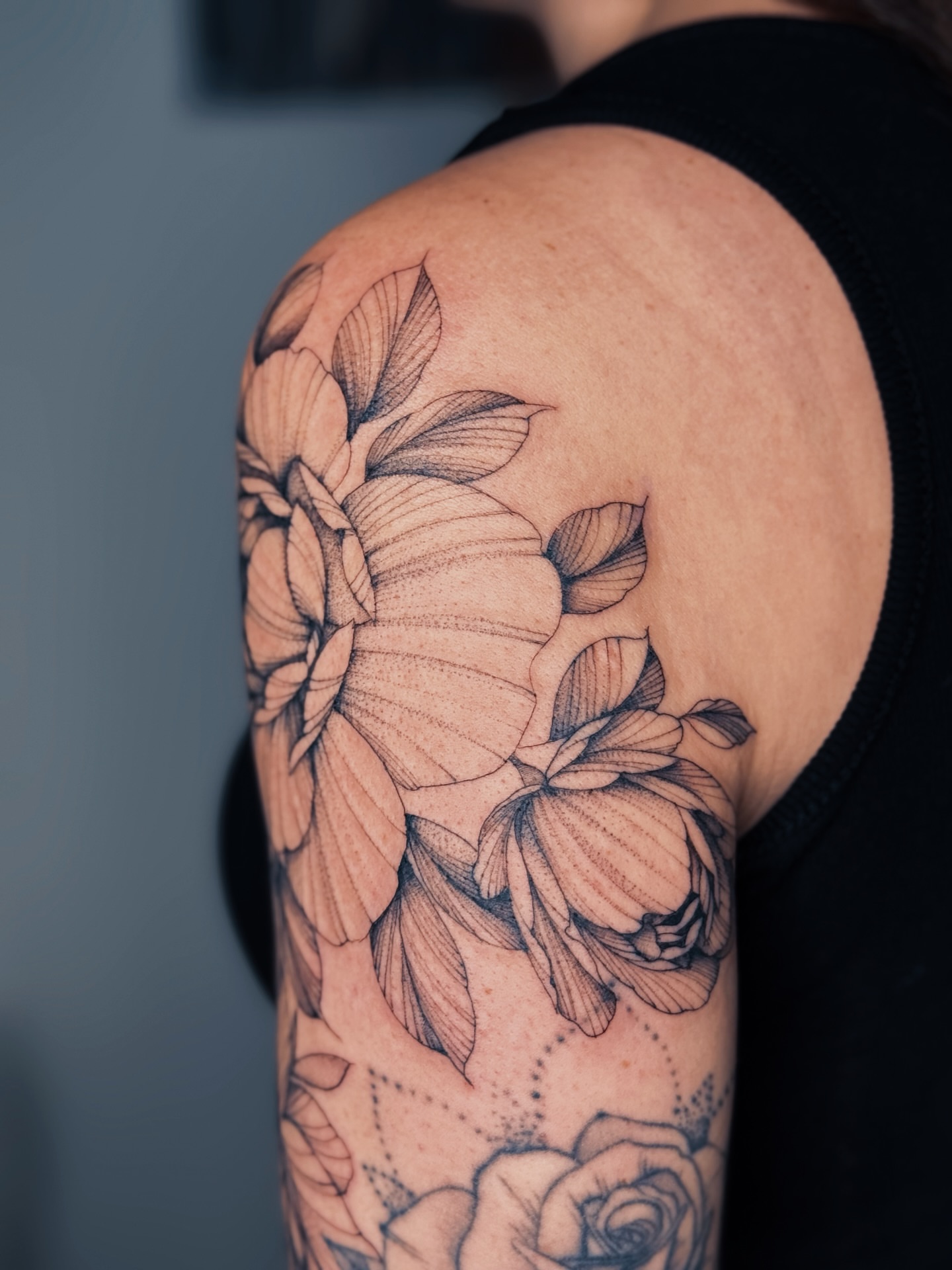 Floral bouquet dotwork tattoo on the shoulder by Olha Tytarenko