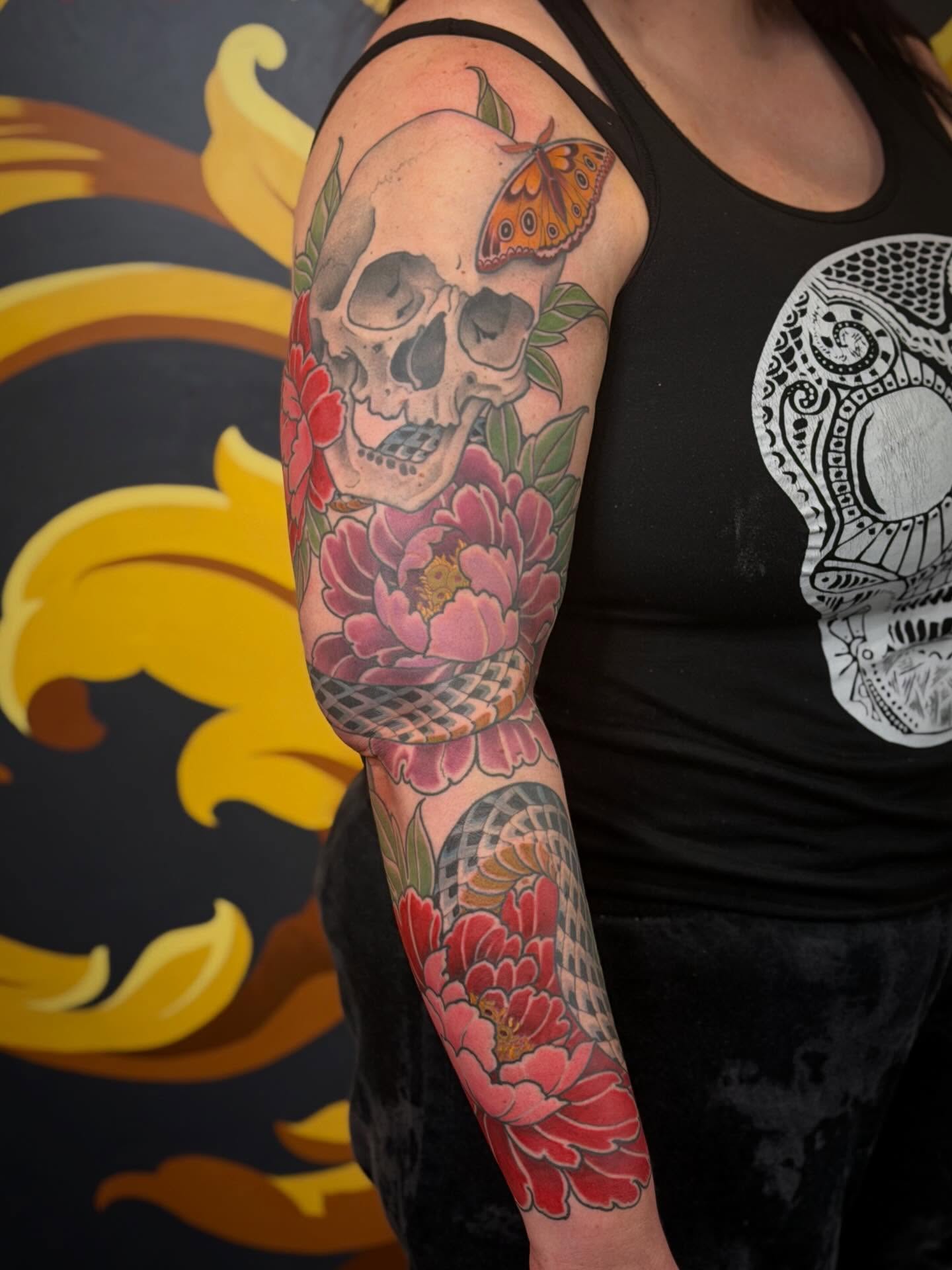 Skull and flowers American traditional tattoo on the forearm by English Cousins, Nashville, Tennessee