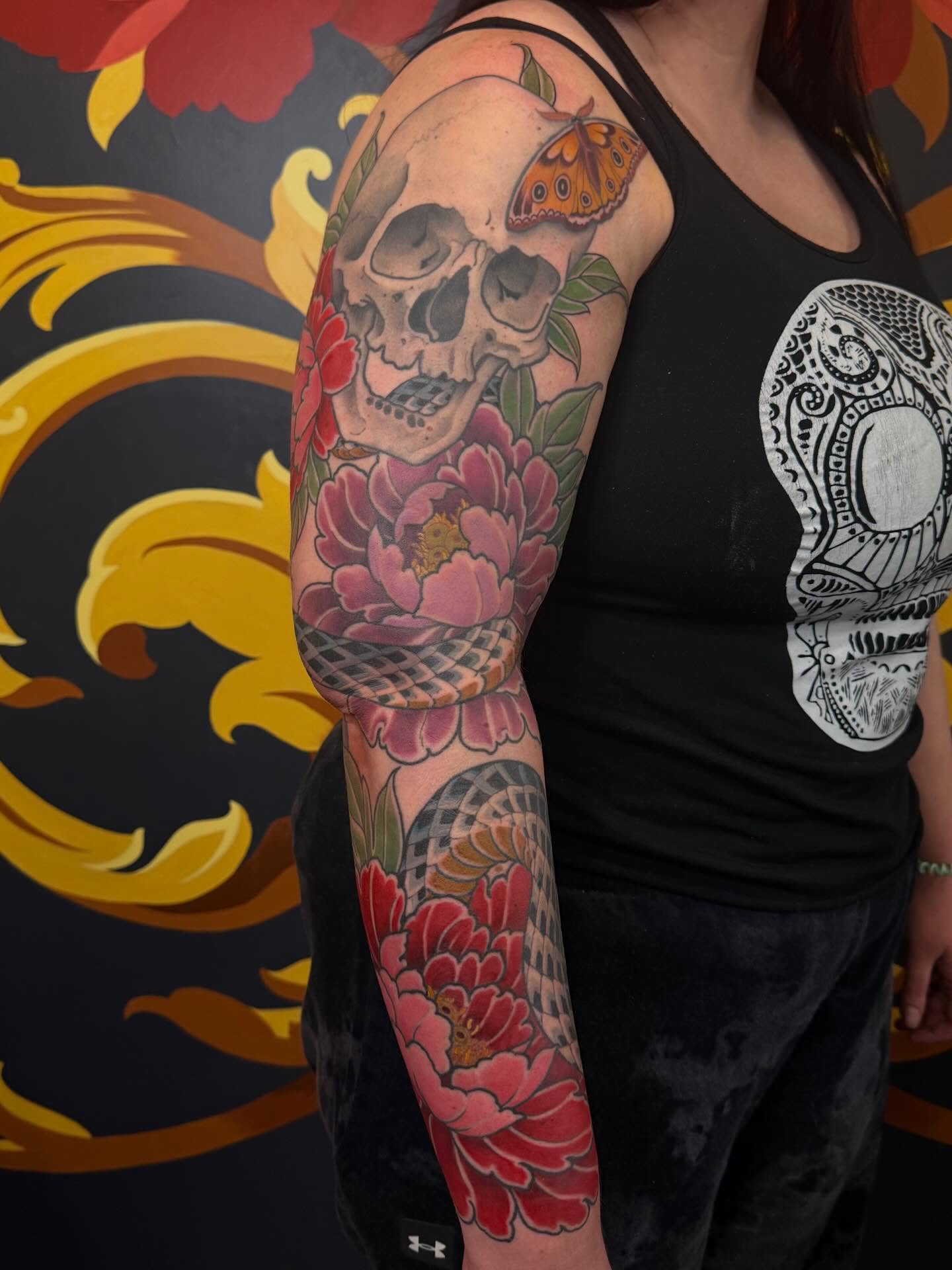 Skull and flowers American traditional tattoo on the forearm by English Cousins, Nashville, Tennessee