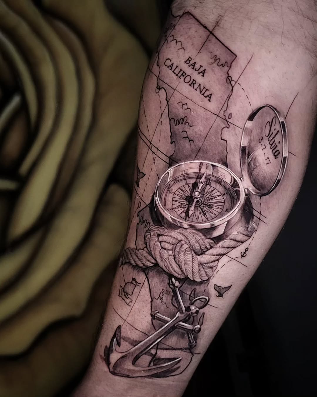 Compass, anchor, rope, and map surrealism tattoo on the forearm by Pod Viñes