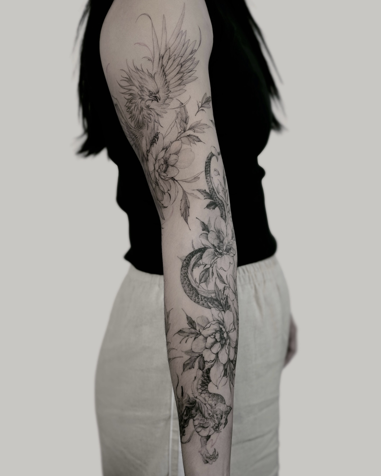 Floral and bird realism tattoo on the forearm by Yeonji