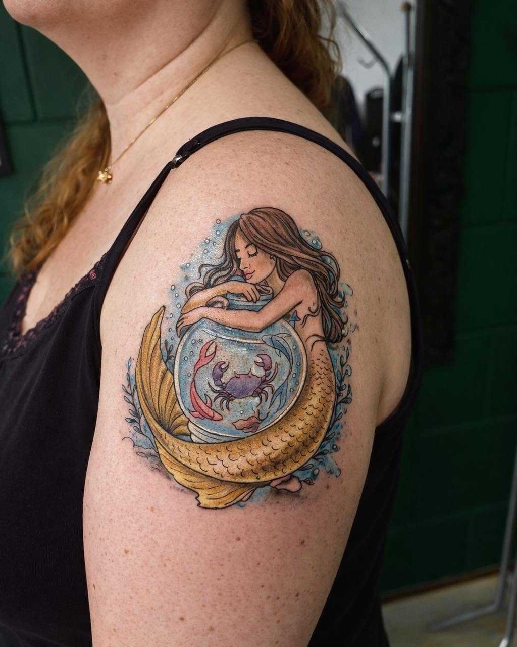 Mermaid holding a jar realism tattoo on the shoulder by Léon Huiting