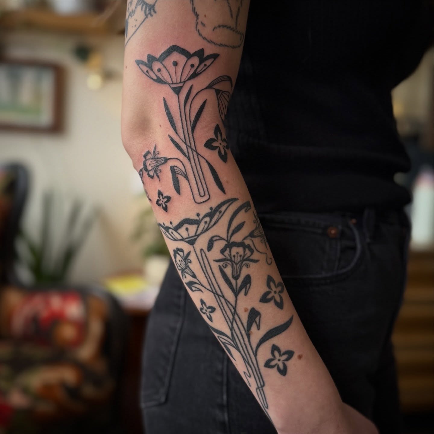 Floral arrangement black and grey tattoo on the forearm by Leah - Tattoo Artist