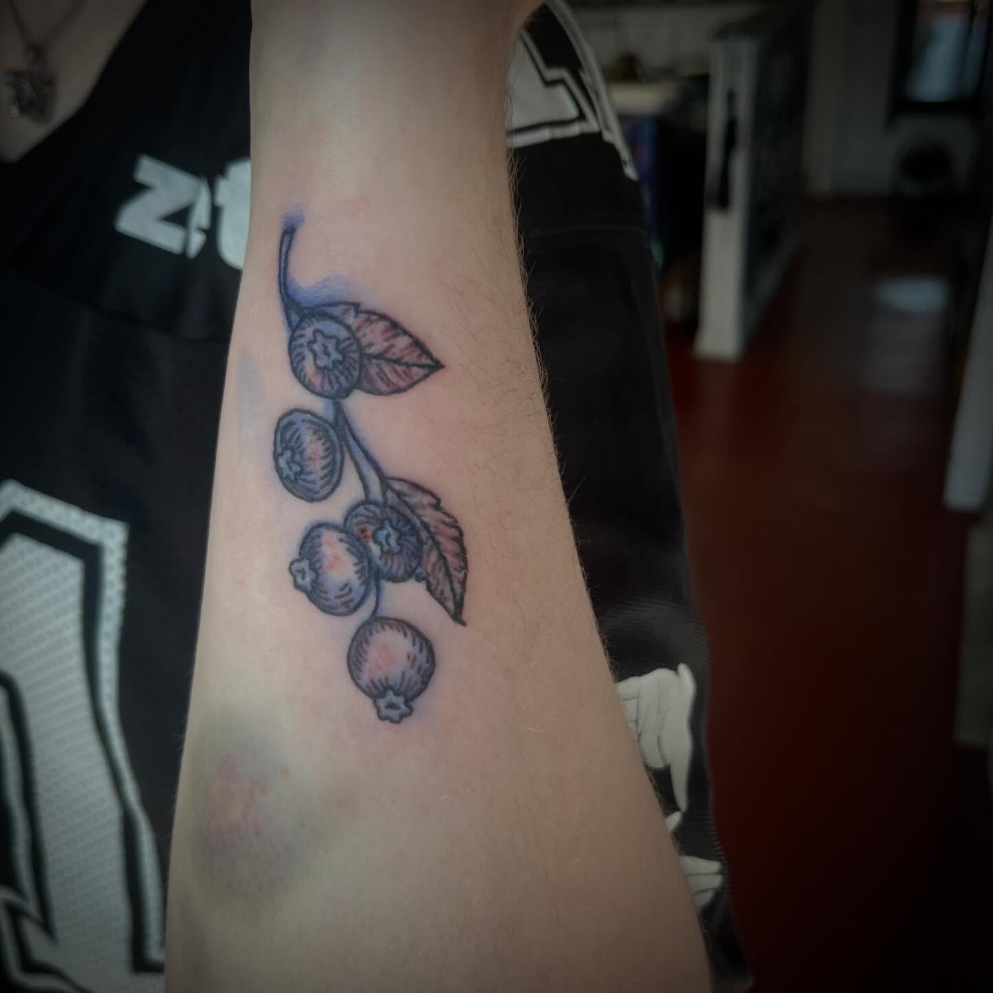 Blueberries realism tattoo on the forearm by Rafaela Lopez
