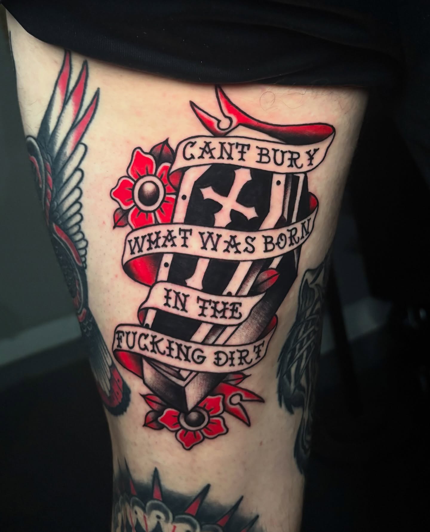 Cross and banner American traditional tattoo on the thigh by Shiann Null