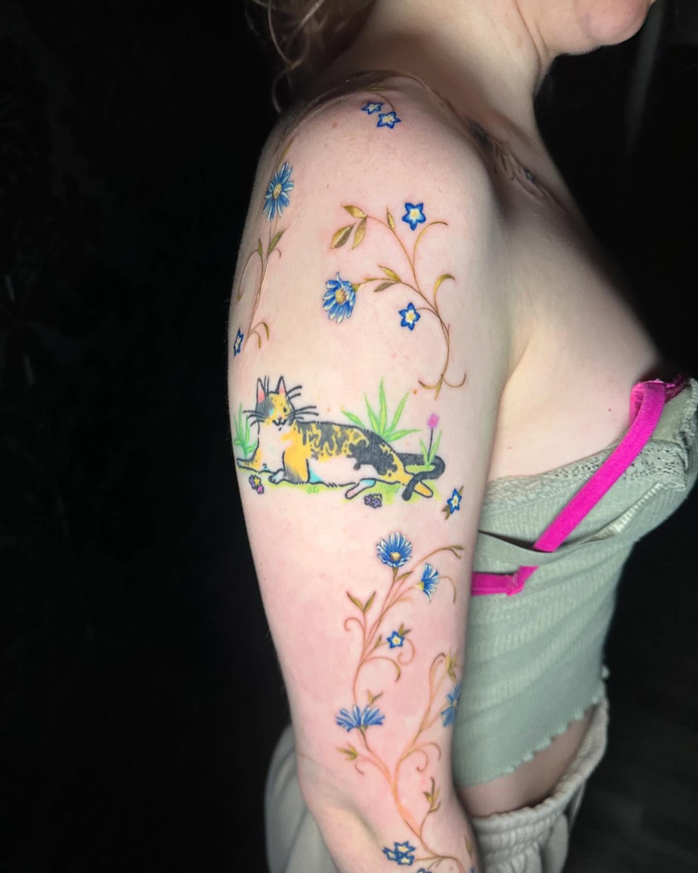 Cat and flowers watercolor tattoo on the upper arm by Cassandra Rasper-Beard