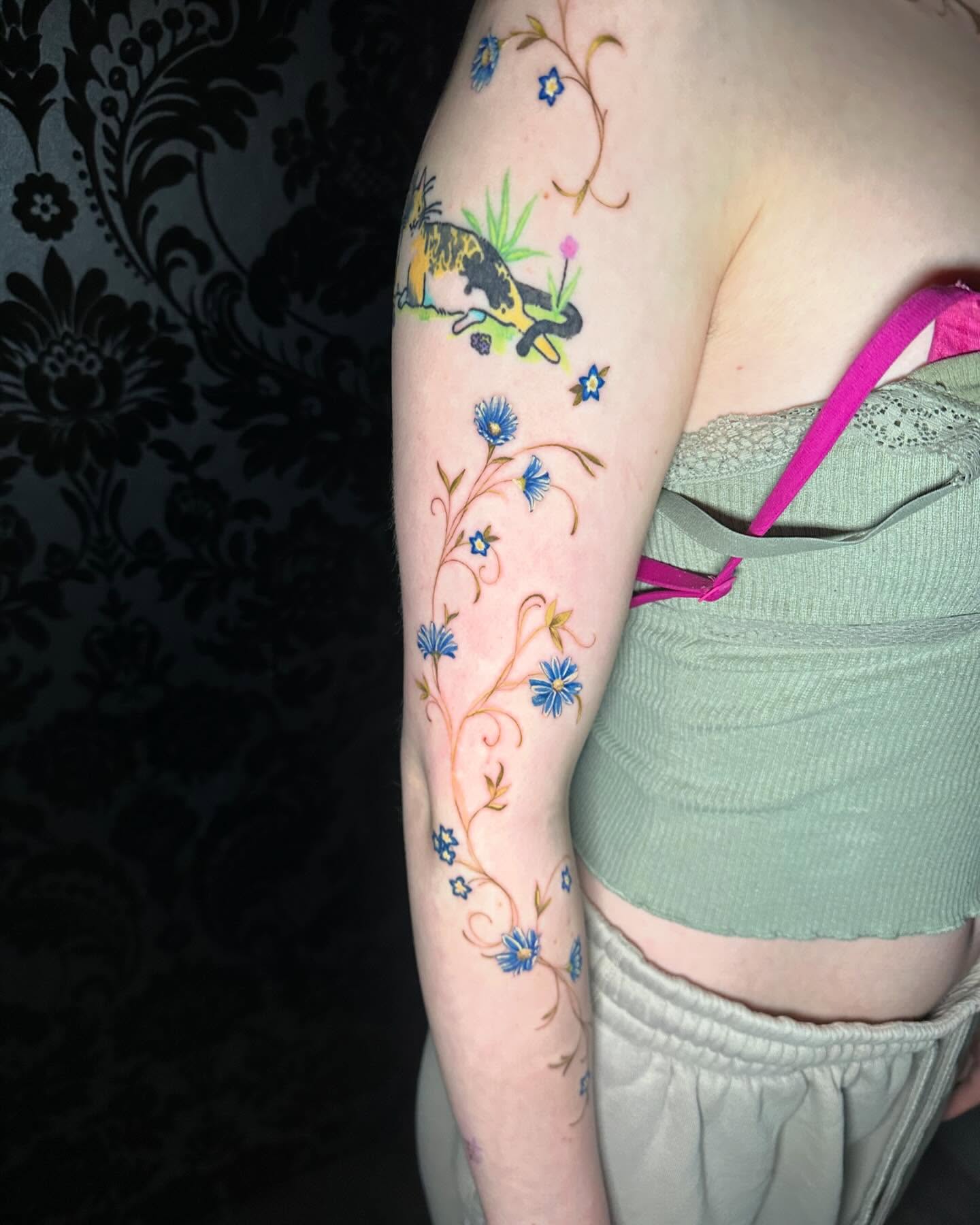 Cat and floral vine new school tattoo on the forearm by Cassandra Rasper-Beard