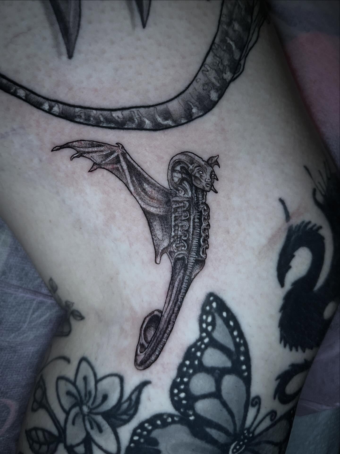 Bat black and grey tattoo on the torso by Sierra
