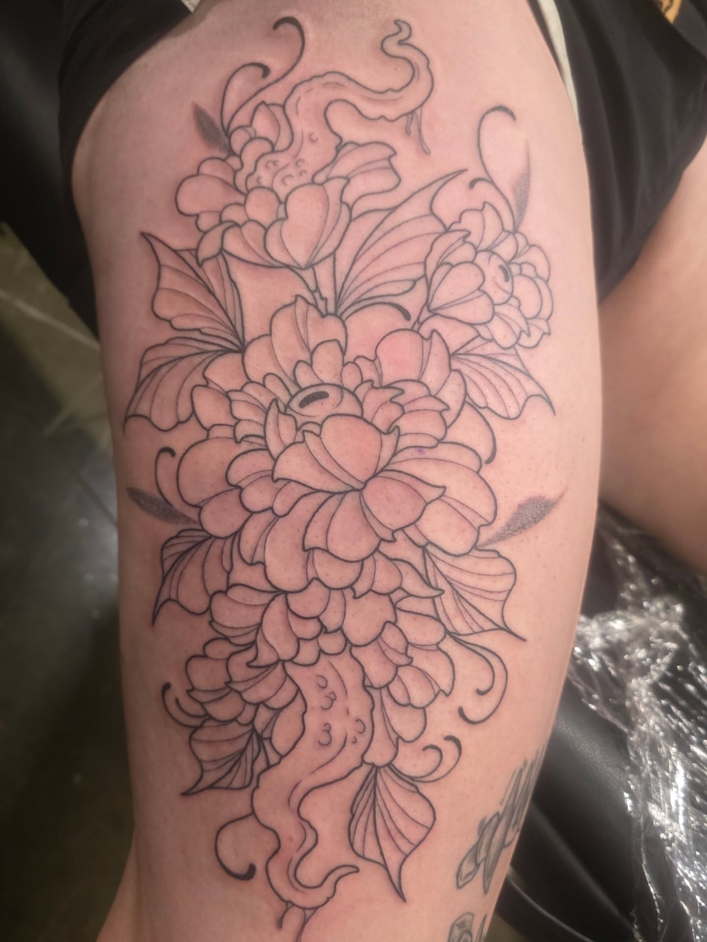Peony bouquet black and grey tattoo on the thigh by Mandy Rizzuto