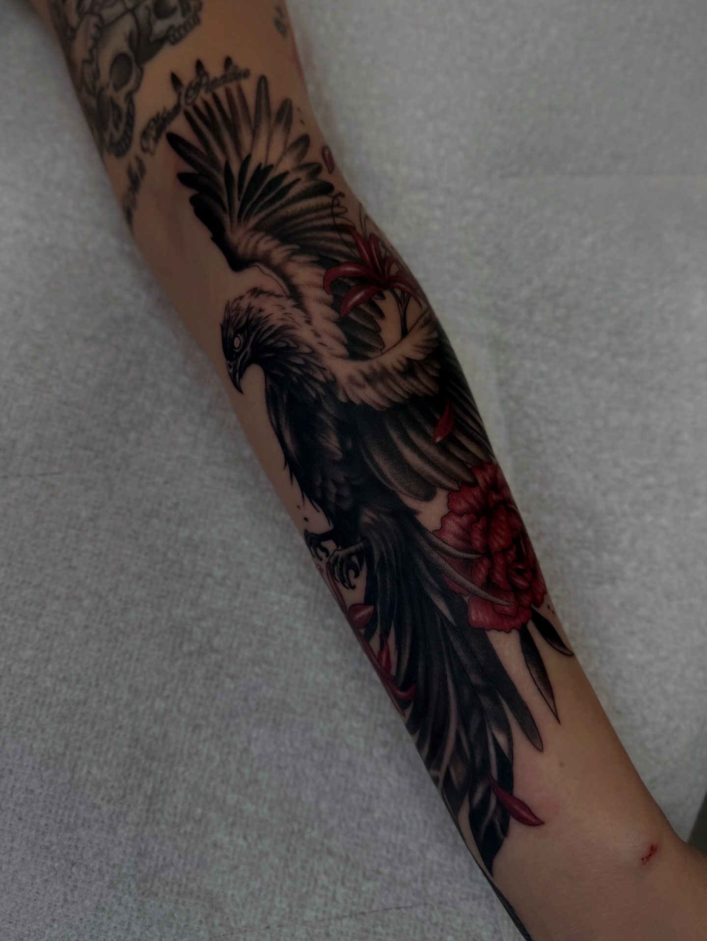 Eagle and flowers American traditional tattoo on the forearm by Sacramento Tattoos (Ilona)