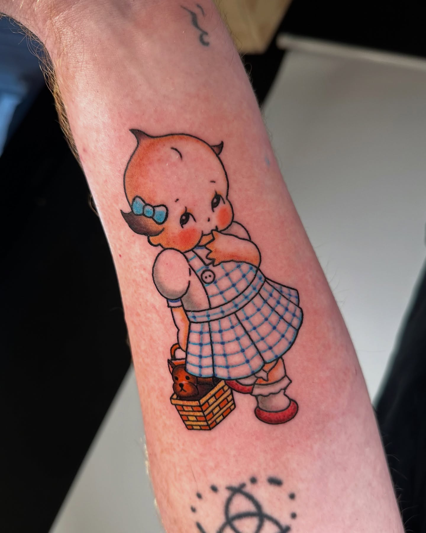 Baby with basket American traditional tattoo on the forearm by Ash Gonzalez ❤️ Austin Tattoo Artist