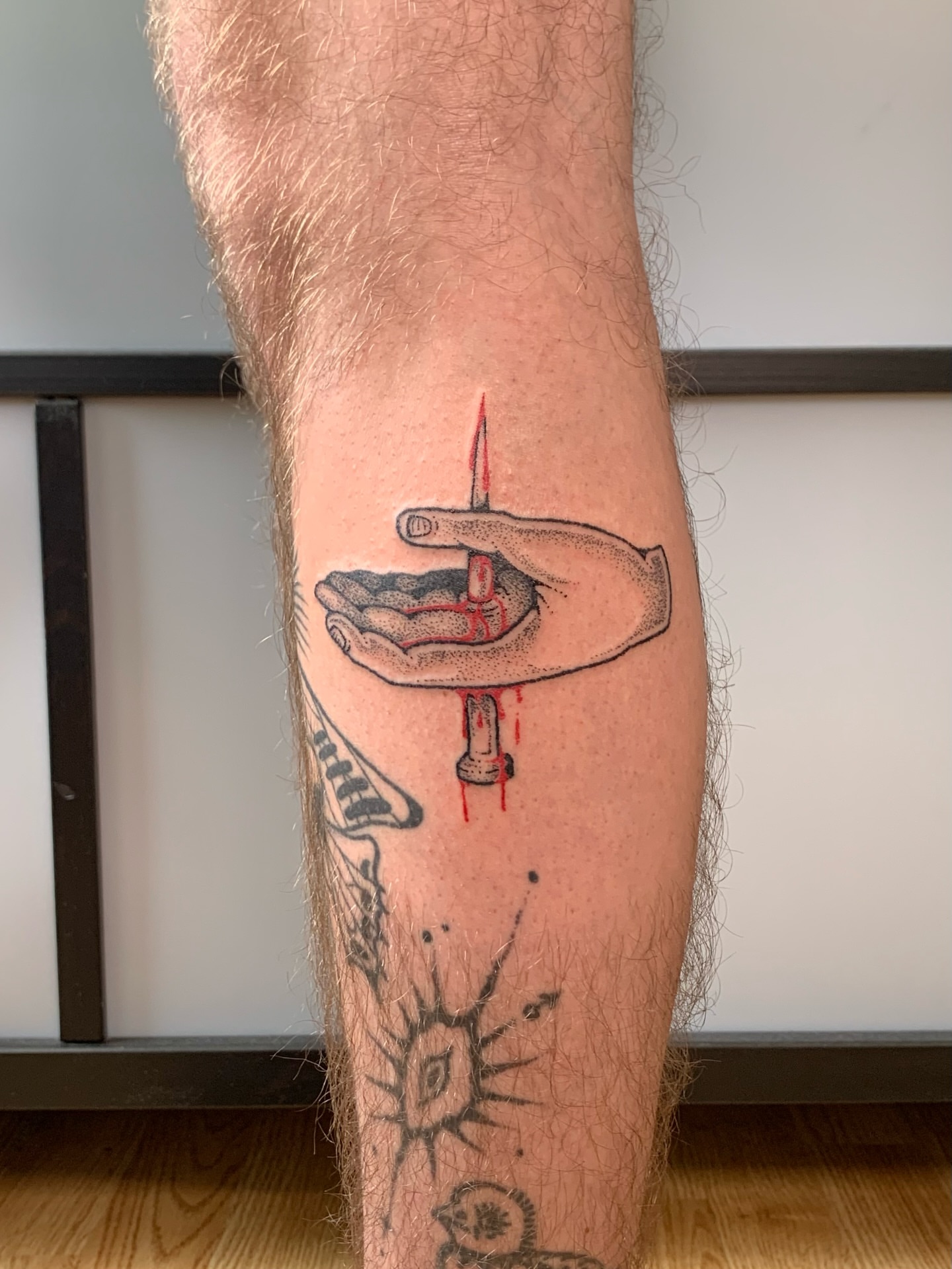 Hand holding candle American traditional tattoo on the forearm by Lex Lloyd