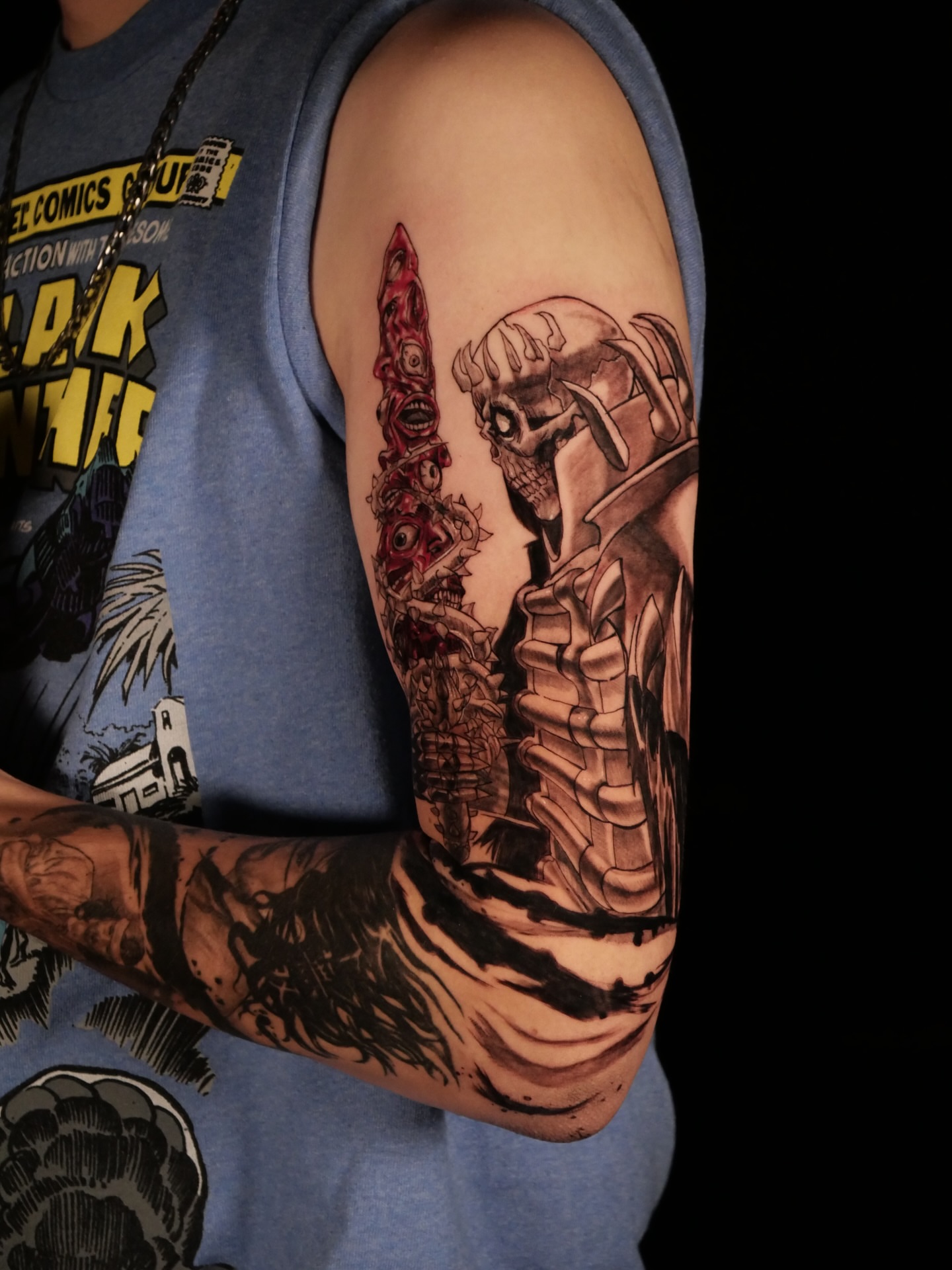 Cyborg figure dark realism tattoo on the upper arm by Sloppy
