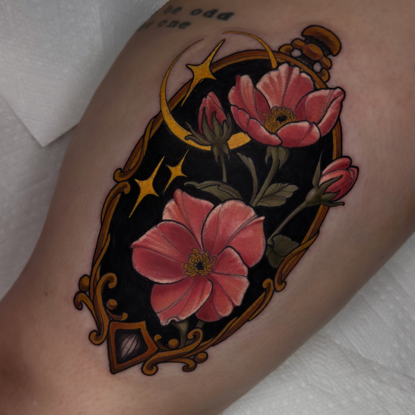 Flowers and crescent moon new school tattoo on the thigh by Golden Heart Tattoo Co