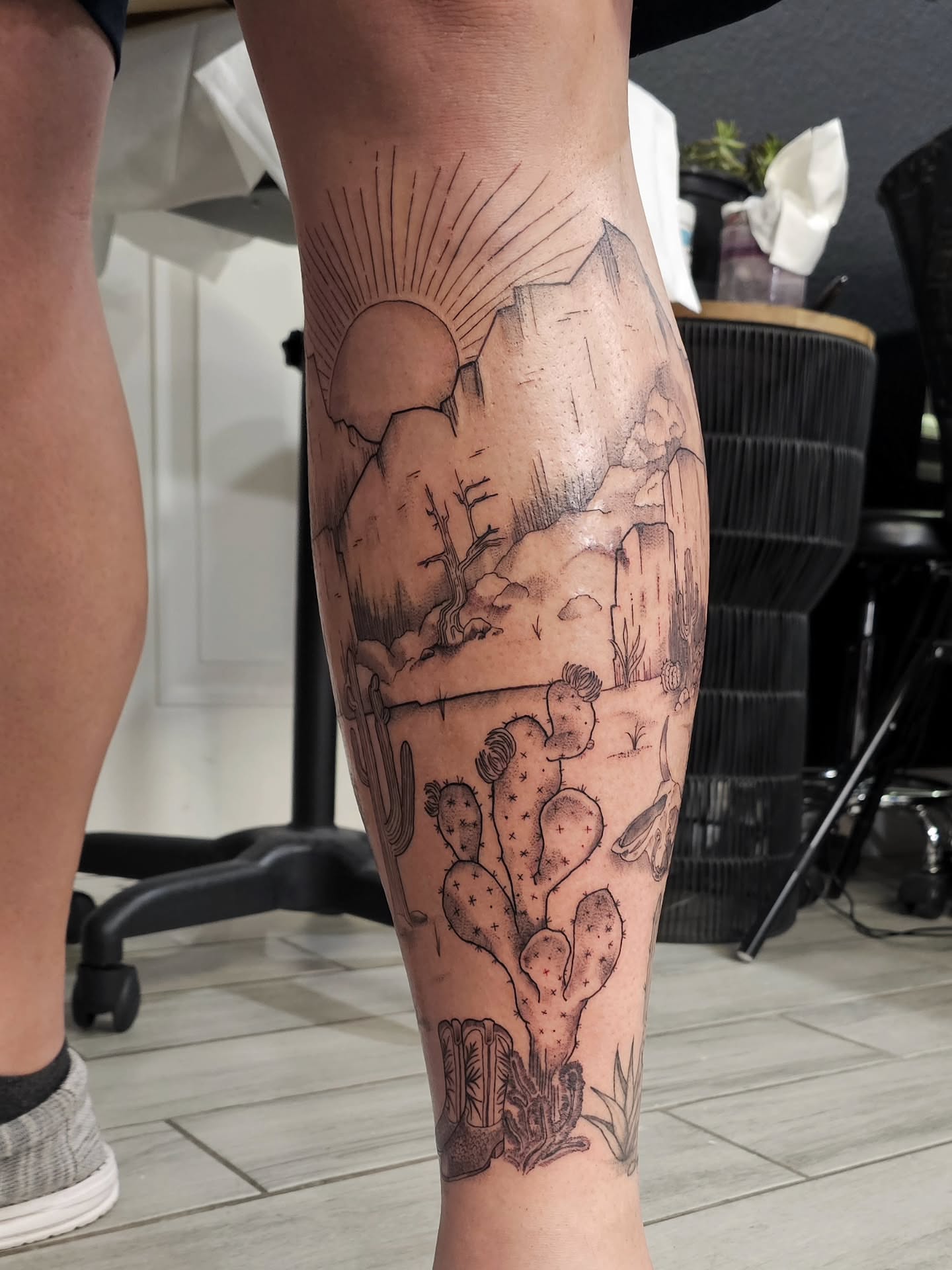 Desert landscape realism tattoo on the calf by Casey Jo