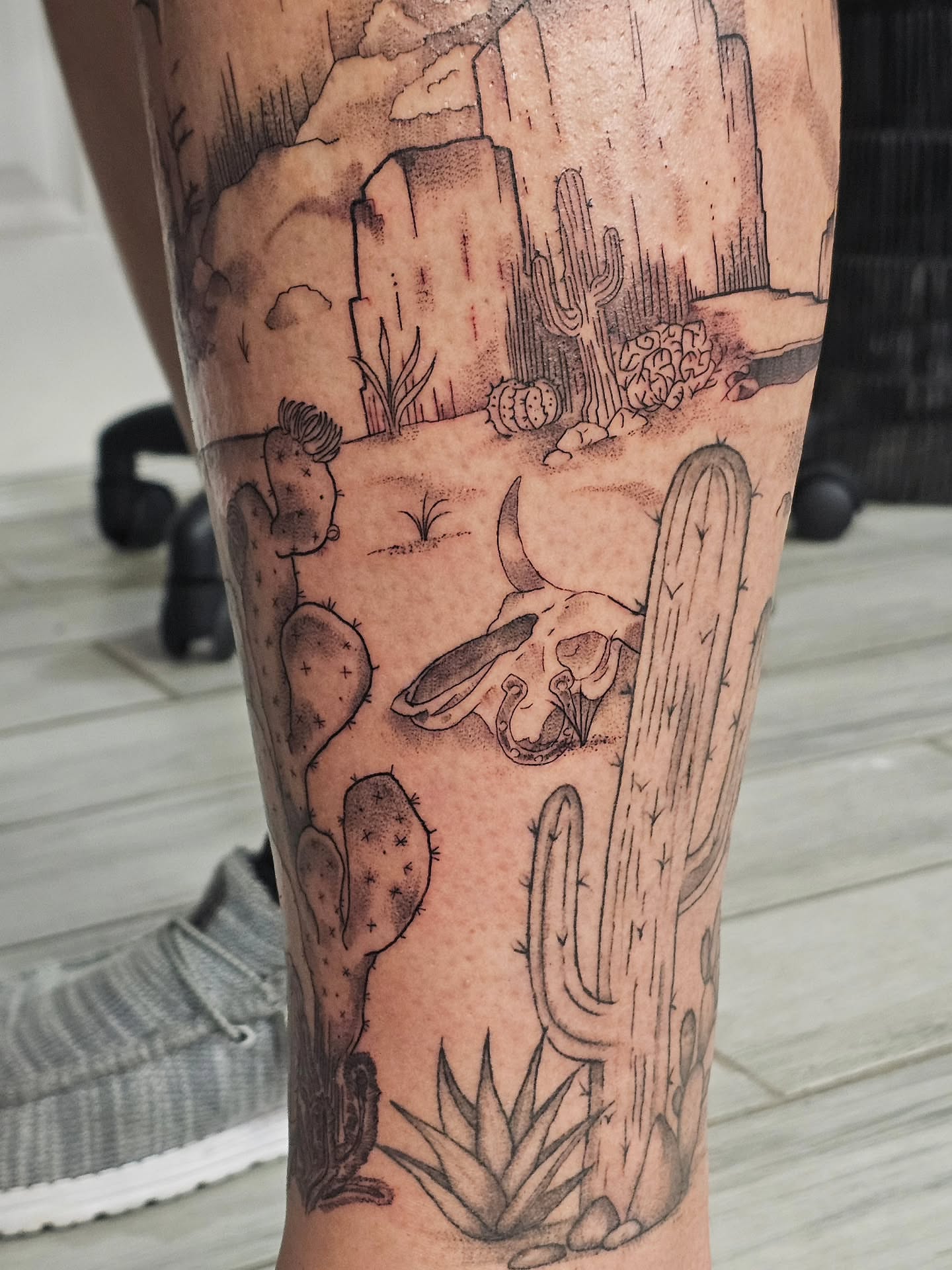 Desert landscape realism tattoo on the leg by Casey Jo