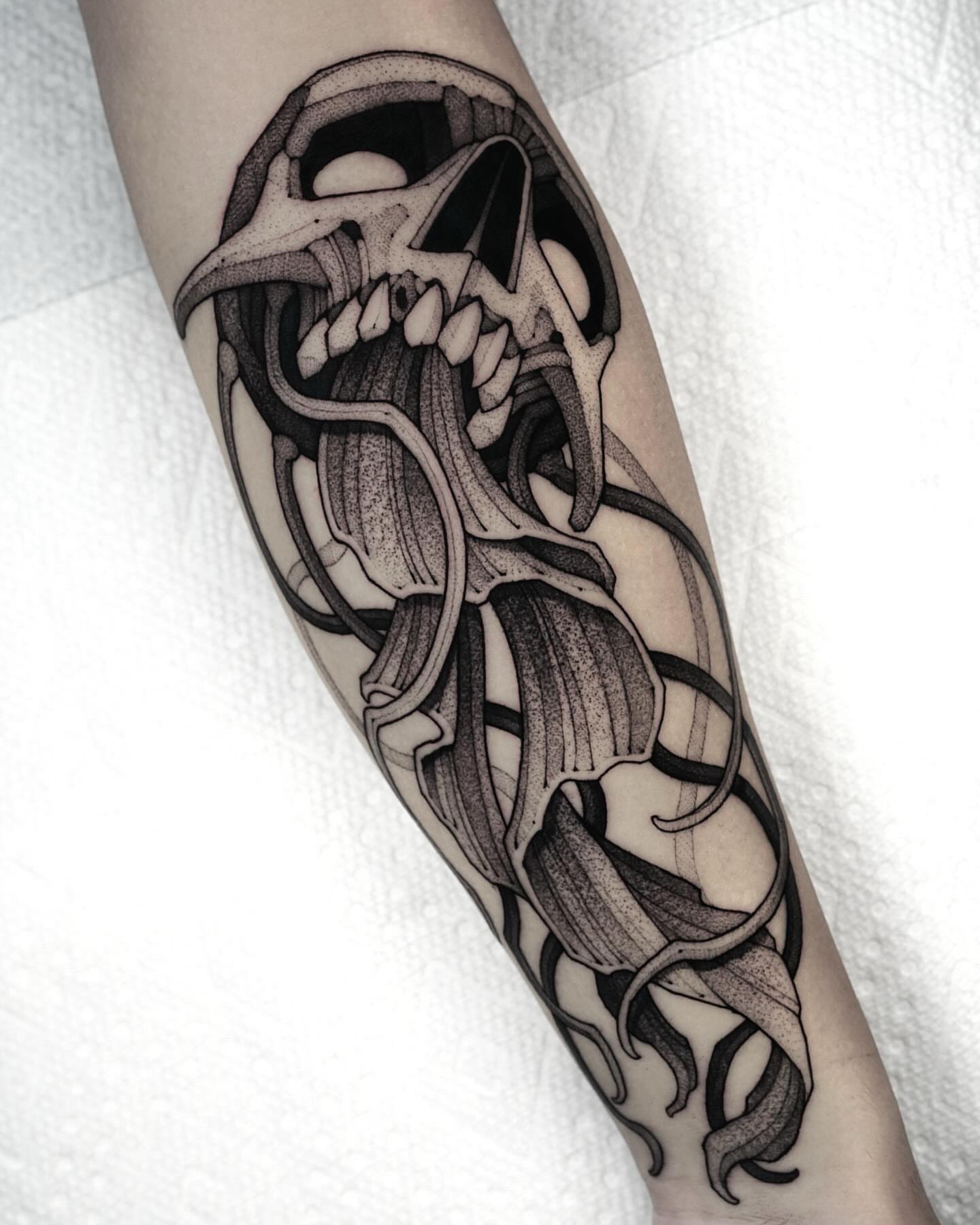 Skull and calla lilies geometric tattoo on the forearm by Max LaCroix
