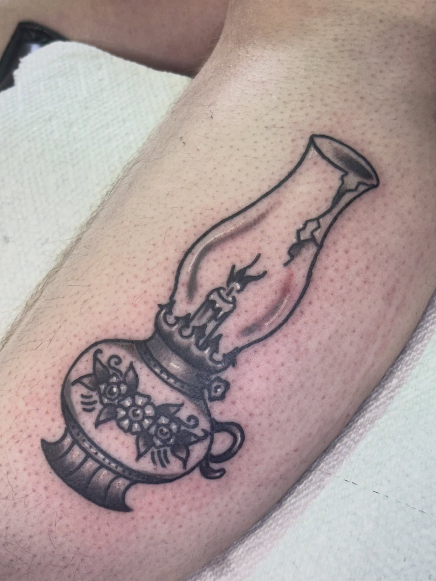 Oil lamp black and grey tattoo on the forearm by Erica Mirella