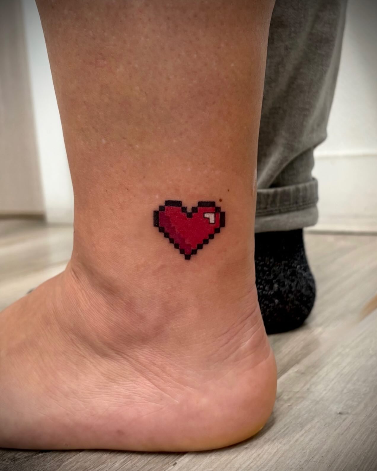 Pixelated heart dotwork tattoo on the foot by Deborah