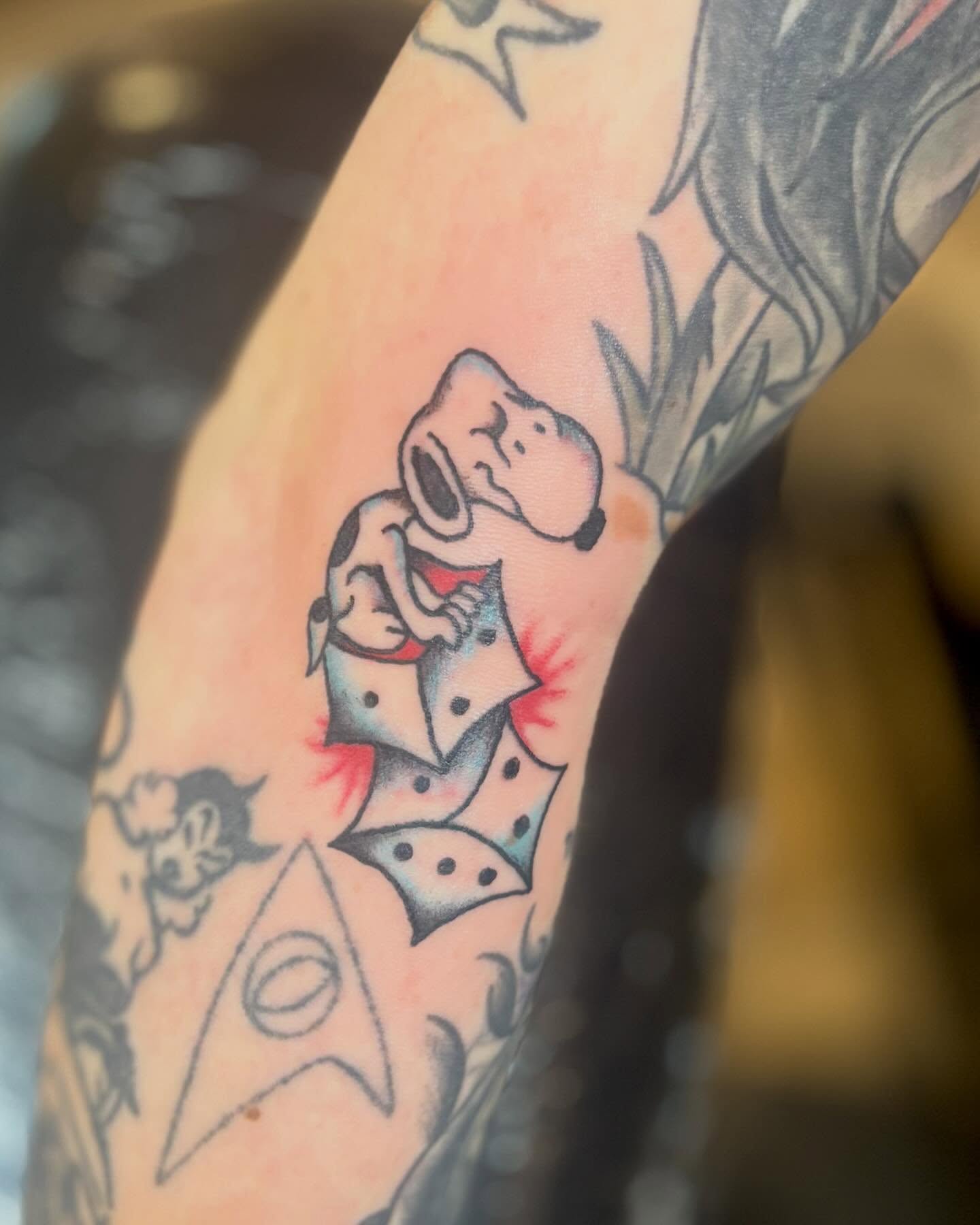 Dog and playing card dotwork tattoo on the forearm by Tia Cave