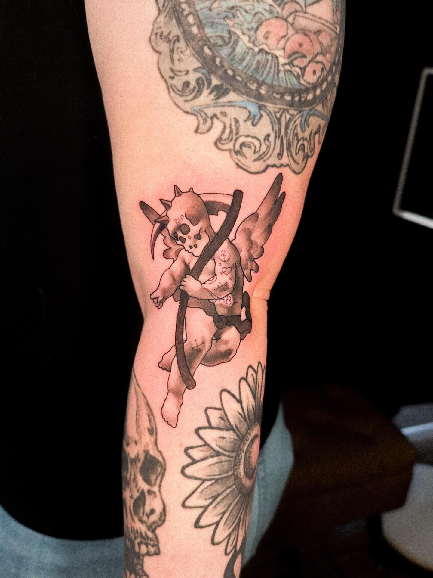 Cupid neo-traditional tattoo on the forearm by Nathan Thomas