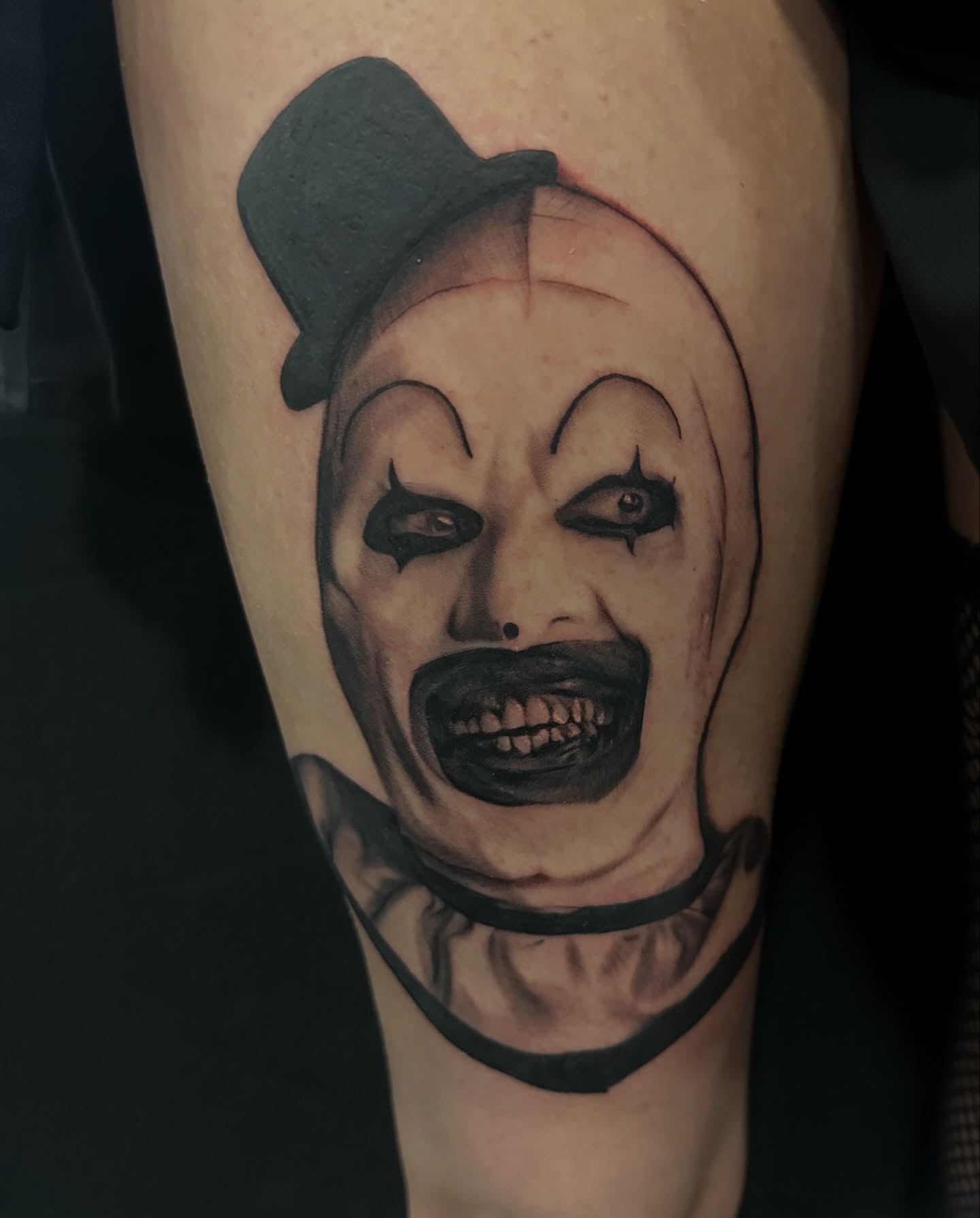 Clown realism tattoo on the forearm by Sideshow Danny